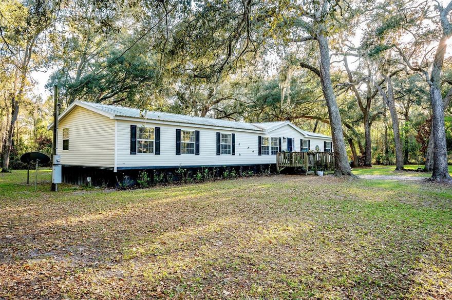 Welcome to your slice of North Florida paradise! This beautifully maintained 4-bedroom, 2-bath manufactured home in Trenton sits on an oversized 1.42-acre double lot, offering the perfect blend of space, comfort, and location. Inside, you’ll find both a spacious living room and a separate family room, ideal for entertaining or spreading out, along with updated flooring, fresh paint, new cabinets, countertops, and modern vanities throughout. All bedrooms feature generous closet space, while the primary suite boasts an additional living space that could be easily used as a home office, gym or nursery, as well as a large walk-in closet you’ll love. The home is topped with a durable metal roof and has been thoughtfully updated, making it truly move-in ready. Step outside and enjoy the peaceful surroundings, with plenty of room for outdoor living, gardening, or storing your toys. Nature lovers will appreciate being just 3 miles from Fanning Springs and within 15–20 minutes of other stunning springs like Hart Springs, Otter Springs, and Manatee Springs, perfect for swimming, kayaking, and soaking up Florida’s natural beauty. Plus, you’re just a short drive to Cedar Key for coastal charm and to University of Florida, one of the nation’s top public universities, known for its strong academics, vibrant campus life, and unbeatable school spirit. Whether you’re looking for a full-time residence, weekend getaway, or investment opportunity, this property checks all the boxes! Call to schedule your private showing. You don't want to miss this one!