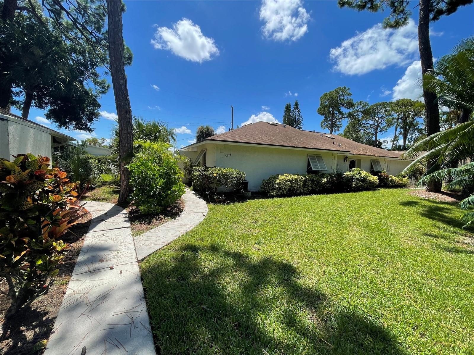 This villa is a rare find, featuring a remodeled 2BR 2BA layout with a beautiful enclosed rear lanai and an outside wrap-around patio designed for outdoor Florida living. The privacy fence across the backside adds to the allure of this property, while the new Florida foliage and outside lighting create a tranquil atmosphere for relaxation. Among the 12 villas in the community, this property stands out with its cathedral ceilings and three skylights (BRAND NEW ROOF AND SKYLIGHTS 2025). The kitchen is elegantly designed with granite countertops, stainless appliances, and a large sink, while matching ceramic tile extends throughout the home as well as the spacious enclosed lanai with storage and hurricane shutters. Both bathrooms feature higher toilets, and a unique atrium off the Master Bathroom adds a touch of charm. An additional outside metal shed provides extra storage space. This property offers both charm and practicality, making it an appealing choice for those seeking a home in Sarasota. Experience the best of both worlds. Nestled in the city’s art district, this peaceful and quiet community offers easy access to downtown and Sarasota's attractions, including the Ringling Museum, Ringling College, Van Wezel Performing Arts Hall, Asolo Theatre, Sarasota Airport, and Lido Beach. Furthermore, the property benefits from an HOA fee covering the roof, and property remained unscathed by hurricanes, making it a secure investment. Notably, this community is not age-restricted, and owner occupants are allowed up to two domestic pets weighing up to 35lbs each (dogs and cats). Hot Water Heater (2022). Come live the Florida lifestyle you've been dreaming of.
