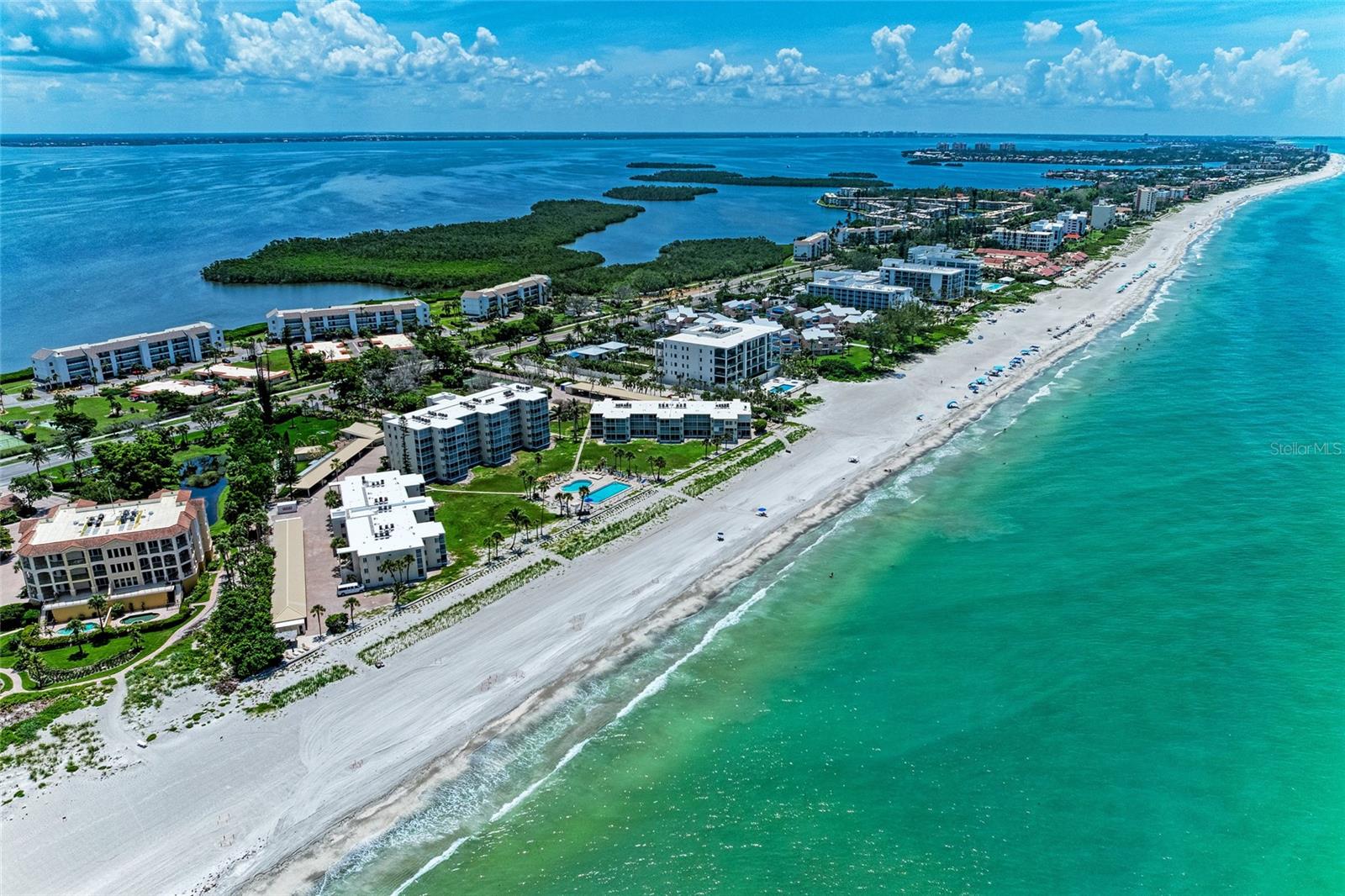 Enjoy direct views of the turquoise Gulf, miles of pristine beach, and effortless coastal living in this turnkey-furnished, first-floor walkout residence. In The Westchester on Longboat Key, this roomy two-bedroom, two-bath condominium offers a well-designed split floor plan and convenient indoor-outdoor living. The unit is attractively furnished in a coastal style, and the living room and dining room include a built-in entertainment center and serving buffet. The kitchen features stainless steel appliances, generous counter space and ample storage. Both bedrooms offer en-suite baths and dual closets, with primary suite boasting a private screened lanai. The larger lanai off the great room frames the stunning Gulf views and provides a gateway to the pool and beach. The Westchester’s mid-key location offers an ideal lifestyle, providing convenient access to Publix Super Market at the Shoppes of Bay Isles, as well as pharmacy, banking and fitness centers. You also have quick access to Centre Shops, Whitney Plaza, and numerous north end waterfront restaurants and cafes, including the bayside Shore Restaurant and Mar Vista. Community amenities include lighted tennis and pickleball courts, two heated pools, shuffleboard, outdoor grills and cabanas, kayak and bicycle storage, as well as private storage lockers for your beach essentials. A newly renovated clubhouse is coming soon, featuring a full kitchen, lending library and fitness area. Assigned covered parking and an in-residence laundry offer added everyday convenience. The community fosters a welcoming and neighborly environment. Longboat Key is home to a private golf course, a full-service marina, waterfront parks and an array of dining options. Nearby destinations include St. Armands Circle and downtown Sarasota. Rentals are permitted, offering excellent flexibility for seasonal or full-time ownership. Schedule your private showing today and discover the effortless Gulf-front lifestyle this residence offers.