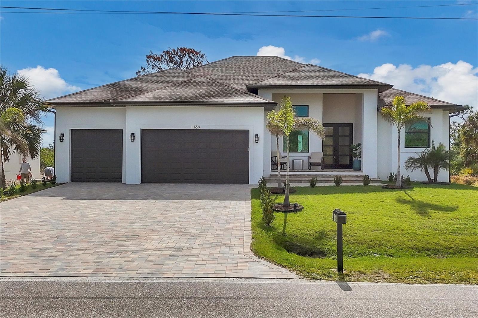 A RECENT PRICE IMPROVEMENT MAKES THIS HOME A MUST-SEE! This custom-crafted home was thoughtfully designed to honor its distinctive contemporary style in keeping with the principles that define its simple, elegant aesthetic: an open floor plan, clean lines, minimalistic decor, and a neutral color palette--key elements to a serene and sophisticated Florida lifestyle. Strategically placed windows maximize natural light throughout the residence and capture stunning views of the surrounding environment. Situated on an oversized double .33 acre lot in the highly desired golf community of Rotonda West, the home's stylish exterior is attractive and inviting, with an eye-appealing brick paver driveway and entry and a spacious 3-CAR GARAGE (with an epoxy floor finish). Upon entry, guests feel immediately at home in a carefully curated environment that is infinitely comfortable and effortlessly elegant, designed to accommodate a large gathering or a 5:00 cheeseboard with the same graceful aplomb. With a design that makes the kitchen, great room, and dining room the heart of family life, 12' walls combined with voluminous ceilings define the main living area, creating a space best described as 'spacious but not ostentatious' with style characterized by thoughtful attention to symmetry and proportion. Built-in cabinetry accentuated with floating shelving and a cozy fireplace make this a natural gathering place for family and friends. A fresh interior neutral color palette provides an exciting opportunity for personalization, encouraging the new owner's creativity and ability to experience true simplicity, setting the stage for the latest colors, textures, and materials. The home's heart is an upscale kitchen featuring elegant, understated, frameless wood cabinetry accentuated with Quartz waterfall countertops and an LG black stainless steel appliance package. Expansive triple sliders grace the great room and blur the divide between the indoor and outdoor living areas, thus capturing the essence of Florida living. The oversized lanai provides an all-season style with ample room to create a comfortable seating area that is convenient and easily accessible to the residence, resulting in a gathering spot replete with privacy and a serene view. Here, a built-in outdoor grill and a heated saltwater pool with a natural backdrop of preserved land await. The primary bedroom offers a welcome respite after a sun-kissed day at the beach. Its ensuite bath features sleek contemporary cabinetry, a beautiful free-standing tub, and a spacious walk-in shower. Two additional guest bedrooms offer full baths with beautiful tile showers, accommodating guests in privacy, luxury, and comfort. All bedrooms have walk-in closets and built-in custom storage solutions. This distinctive residence lies within the heart of the highly desired community of Rotonda West, a quiet, friendly community within a short drive to the pristine Gulf beaches of Boca Grande and Englewood. World-class fishing and boating opportunities, delectable dining establishments, and eclectic shopping venues are nearby. In addition, Rotonda West is a golfer's paradise with five courses within the community. For nature enthusiasts, Rotonda West does not disappoint, with its distinctive natural beauty comprised of scenic lakes and canals. If this sounds intriguing, call today to schedule a private showing, and prepare to be captivated by this vibrant community where every day is a vacation.