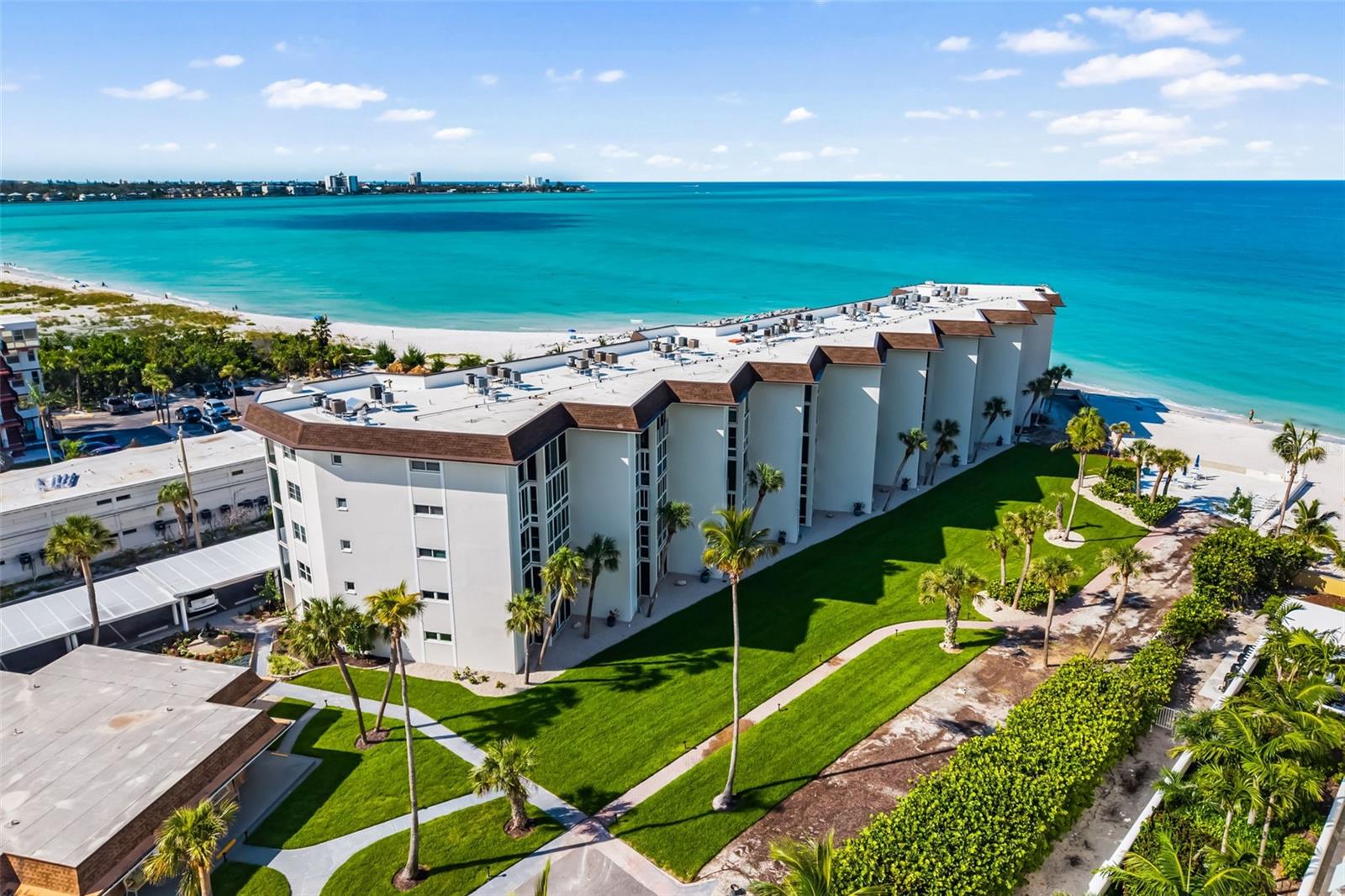 A slice of heaven awaits! BEACHFRONT residence at Lido Harbour South, Seaview building offering an unmatched Gulf-front lifestyle, where every day begins and ends with breathtaking views of the aquamarine waters and pristine sands of Lido Beach. Set within a GATED community and perched on the third floor, this 2-bedroom, 2-bath unit boasts over 1,200 SF of open-concept living. The layout flows seamlessly from the well-equipped kitchen through the living and dining areas to the glass-enclosed lanai. Outfitted with IMPACT GLASS WINDOWS and showcases spectacular views of the Gulf. The lanai becomes your private front-row seat to coastal serenity. The spacious primary suite features an ensuite bath and walk-in closet, offering flexibility to accommodate in-unit laundry. The second bedroom is located toward the front of the unit with easy access to the second full bath, perfect for guests. Additional perks include an assigned covered parking space and a large storage closet on the lanai. Lido Harbour South is a beachfront community with private beach access, a heated pool, clubhouse, and sunset/beach deck. All for a relatively low HOA fee. Ongoing community renovations to be completed: clubhouse (pictures shown are of previous clubhouse and plans are to restore to very similar fashion), ADA-compliant elevator (to be installed in 2026), landscaping, beachfront deck, and more. ALL ASSESSMENTS HAVE BEEN PAID IN FULL BY THE SELLERS. Just outside the gates, Ted Sperling Park invites you to explore nature trails, mangrove tunnels, and enjoy sightings of dolphins and manatees, along with kayaking and paddleboarding. Walk to the Ritz Tiki Bar or Lido Pavilion, or hop on the Bay Runner trolley for easy access to St. Armands Circle. A quick drive over the iconic Ringling Bridge brings you to downtown’s vibrant cultural district, including the Sarasota Opera, Ballet, Theatre, Orchestra, Ringling Museum, Selby Gardens, Marina Jacks, fine dining, and upscale shopping. Whether you’re seeking a full-time residence, seasonal escape, or weekend retreat, this Lido Beach gem offers the perfect Gulf-front charm. Please contact me today for more information or to request your virtual preview or in-person appointment.