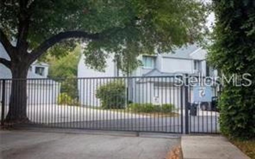 Enjoy living in a private 17-unit gated community in the old Carrolwood area. The community offers a private pool, mature landscape, and a dock overlooking Boot Lake. This home has wood floors, high ceilings, and triple crown molding throughout. The entry area has a half bath downstairs for guests and cathedral-height ceilings with a window extending up to the second floor, bringing in beautiful natural light. A galley-style kitchen with brand-new white quartz countertops and stainless steel appliances provides a pass-through window to the living room. Walking out of the kitchen you will find a spacious multi-use area (coffee bar, kitchen table, office, etc) that leads into the oversized one-car attached garage. This area also has a closet style laundry area that is spacious enough for a side by side washer dryer and storage. The combination living and dining room has a wood burning fireplace and provides access to a private tree lined spacious deck for entertaining. The large second floor master bedroom opens up to a small private deck, has spacious dual walk-in closets with one offering a built-in vanity with lighting. The master bathroom is newly remodeled with a large beautiful shower, dual sinks, a toilet offering privacy and built in wood shelving and accents. The second bedroom has an en-suite bathroom with a large tub, built-in bench, and sliding glass doors. Tiffany Oaks is in a convenient location to all that Carrollwood and Dale Mabry have to offer.