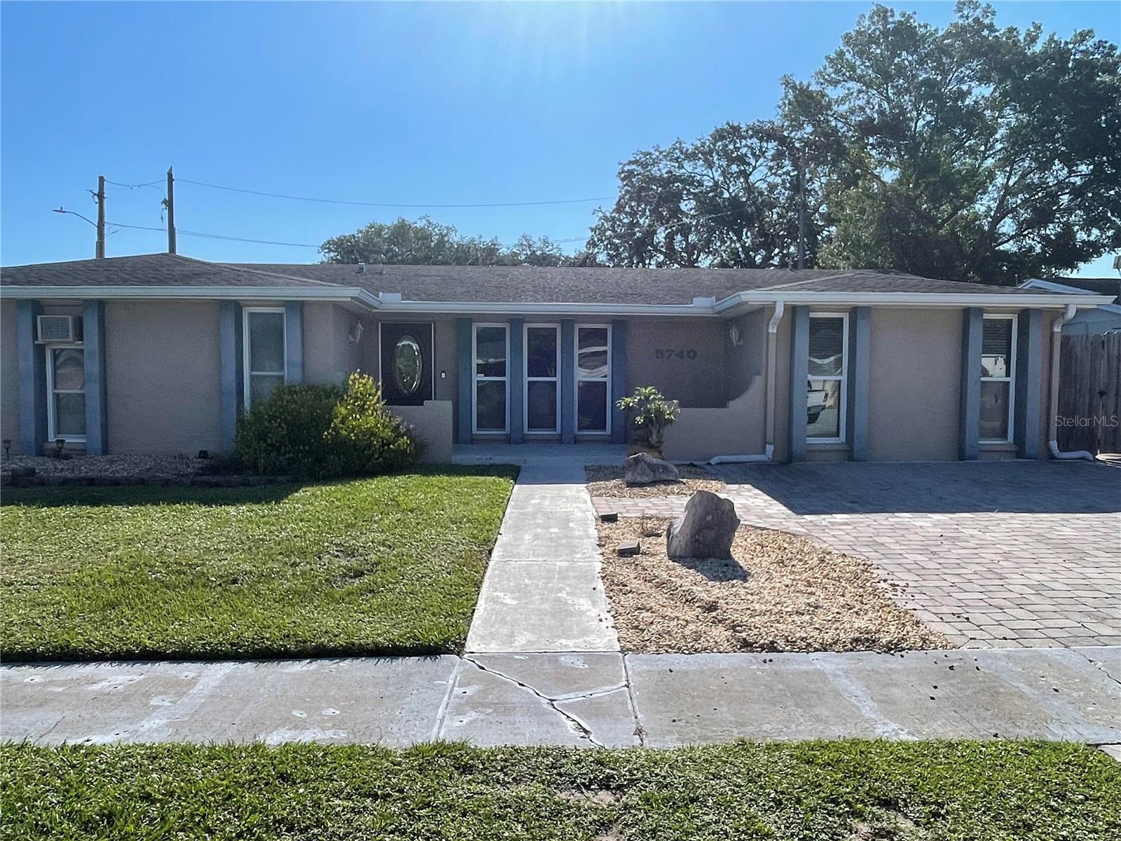 This LARGE REMODELED home has 4 bedrooms and 2 baths, offering 2180 square feet of living space.
The home features two distinct driveway areas for parking. The kitchen is equipped with an island, abundant wood cabinets, and a spacious eat-in area
For outdoor entertaining, there is a built-in grill complete with a refrigerator and bar. Inside, you will find a washer and dryer, an additional storage room, and a covered, screened, paved lanai. The master bathroom includes dual sinks and a walk-in shower.
The fenced-in backyard provides space to store your boat behind a gate. The home also boasts numerous new ceiling fans and updated lighting. Lawn care is included in the rental price, and the driveway is completed with pavers.