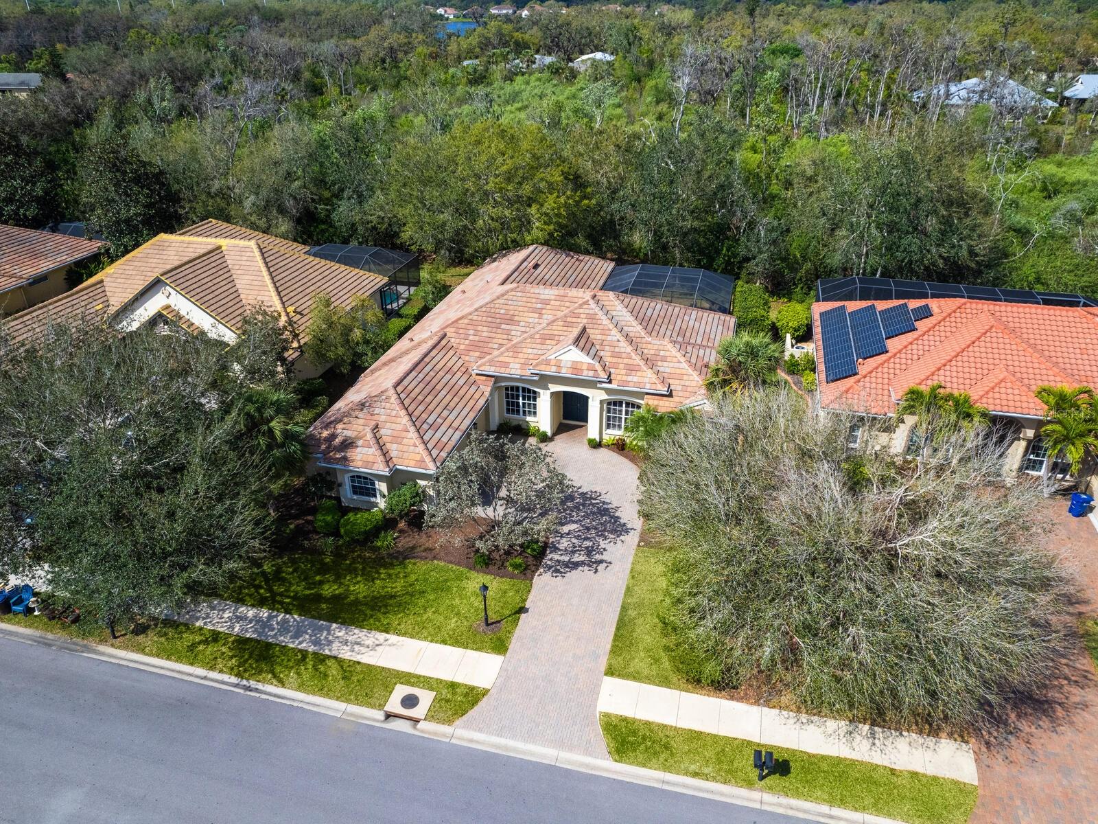 Nestled within the exclusive gated community of Trillium, this beautifully designed single-story home offers a perfect blend of privacy, elegance, and modern updates. Backing to lush PRESERVE VIEWS with Western exposure, enjoy breathtaking sunsets from the comfort of your own backyard in the back of the neighborhood where it is peaceful and quiet. This 4-bedroom, 3-bathroom features IMPACT WINDOWS and a thoughtfully designed floor plan, including a DEDICATED OFFICE with double doors conveniently located near the primary suite. The primary bedroom, expansive fourth bedroom, and both formal and main living areas all boast tranquil views of the private backyard oasis. Inside, the home showcases new, high-end natural wood luxury vinyl plank flooring, adding warmth and sophistication to the space. The open-concept design allows for effortless entertaining, while the kitchen serves as the heart of the home, overlooking the main living areas and offering both style and functionality. Step outside to the covered lanai and enclosed pool, where you can relax in complete privacy with no rear neighbors—just serene greenbelt views. A THREE AND a HALF CAR GARAGE provides ample storage and convenience. Located East of I-75 off Clark Road, Trillium offers a peaceful retreat while being just minutes from Sarasota’s best shopping, dining, and top-rated schools. Experience the perfect balance of luxury, space, and tranquility in this exceptional home.
