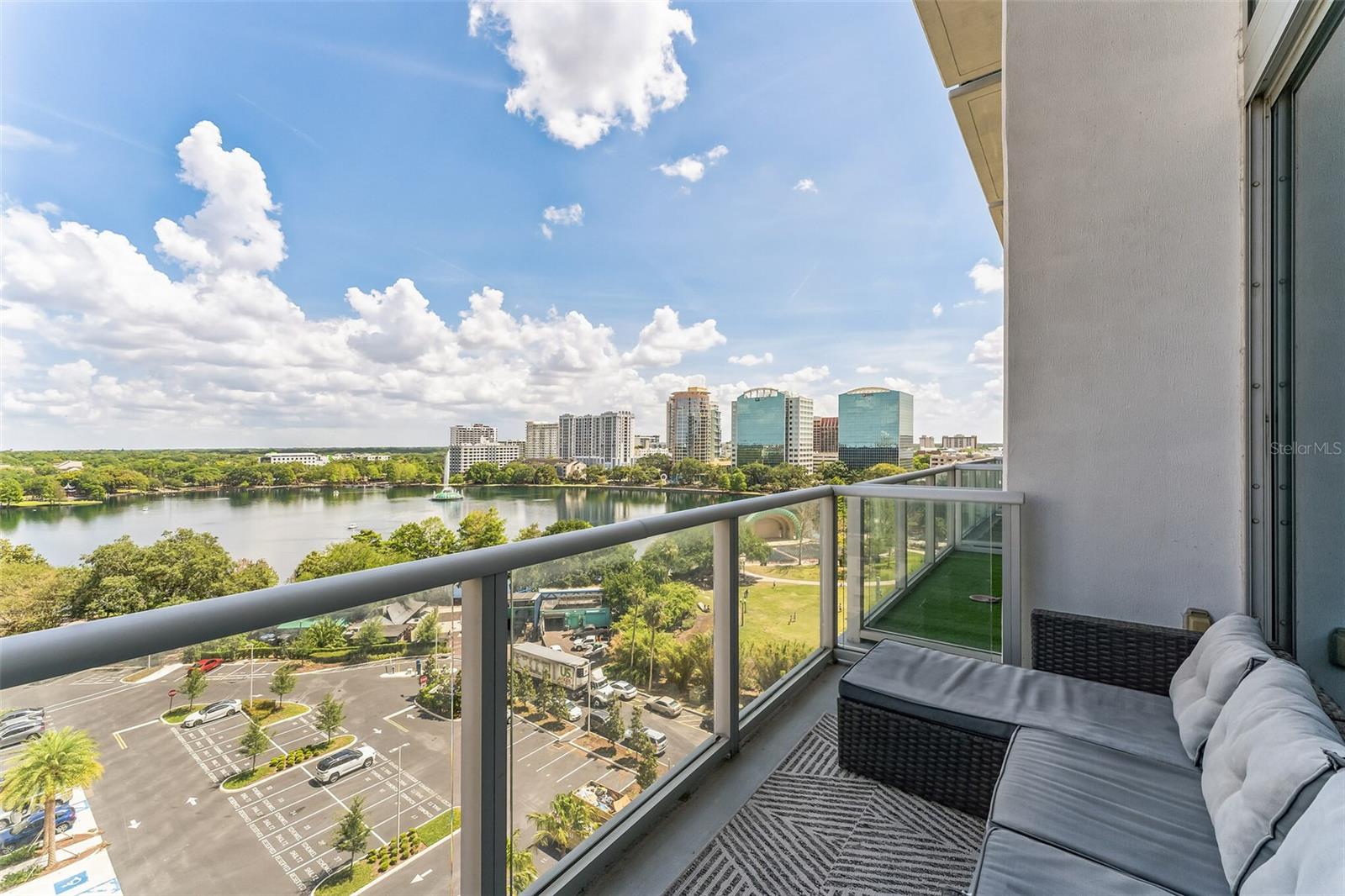 Welcome to 150 E Robinson St Unit 809 in the heart of downtown Orlando! This stunning one-bedroom, one-and-half bath 2 story loft-style condominium boasts modern amenities and breathtaking views of Lake Eola. As you step inside, you'll be greeted by an open and bright living space, with wood-plank tile floors and a 20' tall glass wall allowing for maximum views and tons of natural light. The kitchen features stainless steel appliances, stone countertops, and ample cabinet space. Upstairs, the spacious bedroom/loft features a massive walk-in closet with custom built-ins and a full-size washer and dryer. The bathroom is beautifully designed with a large vanity and a bathtub/shower combo. A remote controlled window shade allows you to easily control the light and privacy of the unit. Enjoy your morning coffee or evening cocktail on the private balcony, where you'll be able to take in the stunning views of Lake Eola. THE VUE is coveted for its world-class amenities which include a 5,000 square foot fitness center, a Junior Olympic-sized swimming pool, tennis/sport court, amenities deck with grills and clubhouse, and a 24-hour concierge for your convenience and security. Located in the heart of downtown Orlando you'll have quick access to all of the city's top attractions: restaurants, bars, the Kia Center, Exploria Stadium, Lake Eola Park, and the Dr. Phillips Center for the Performing Arts are all just minutes away.