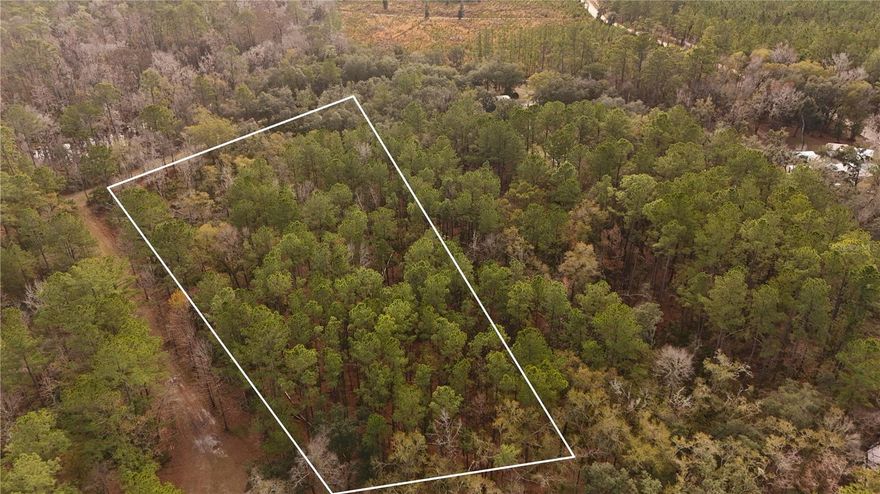 Exceptional Opportunity in Charming White Springs! Build your dream home, mobile or manufactured home, or purchase an investment property on this tranquil vacant 2.1 acre lot on SE 68th Terrace. Adjacent 2.5 acre lot with well already in place, also for sale, see MLS A4676850.  A rare find in this scenic North Florida community. Situated within the River Brook Woods subdivision, this parcel offers peaceful rural living while still being just minutes from the historic heart of White Springs, a town known for its rich heritage and natural beauty. Enjoy access to outdoor recreation and small-town Florida charm with easy proximity to the scenic Suwannee River, parks and trails, and cultural attractions. White Springs is a beloved destination for boating, paddling, fishing, hiking, and bird watching, with a relaxed lifestyle and friendly community. Whether you’re planning a permanent residence, weekend retreat, or rental investment, this property provides a serene setting with modern convenience nearby. Located in an Opportunity Zone, great for investors. Ask agent for details. Don’t miss this chance to secure a foothold in one of Hamilton County’s most storied and peaceful communities. All aerial photo lines are approximate. Buyer to complete their own due diligence.