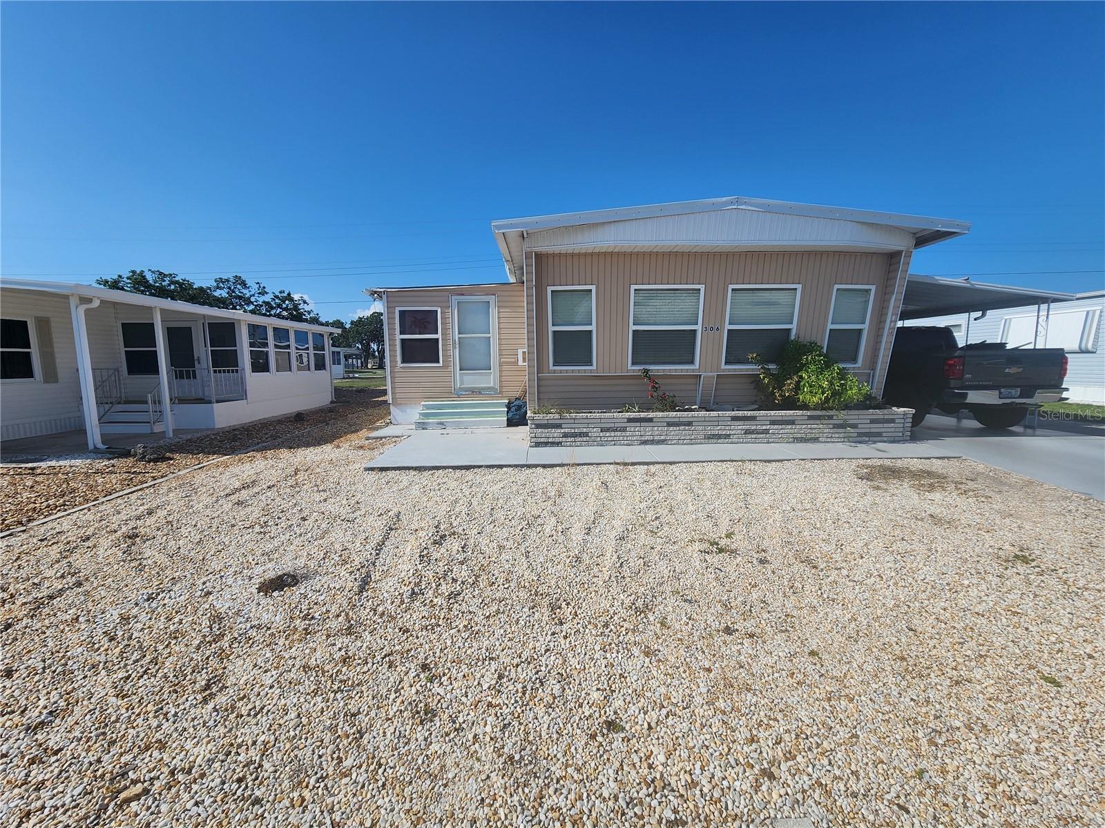 Nestled in a well-kept 55+ community brimming with activities and social opportunities, this home offers both comfort and peace of mind. Thoughtfully updated, it features a new electrical panel installed in 2018, a replaced vapor barrier, and expertly repaired floors to ensure a solid foundation throughout. The plumbing beneath the home has been completely redone, and newer windows invite in natural light while enhancing energy efficiency. The main bedroom boasts a fully replaced subfloor topped with elegant luxury vinyl plank flooring, adding a touch of modern sophistication. One of the few units built on a concrete slab, it offers extra stability and durability. The kitchen shines with newer cabinets and appliances, complemented by custom window blinds that add privacy and style. Central air conditioning was updated in 2008, and new ductwork was installed along with the vapor barrier. Located just minutes from beautiful beaches, shopping centers, and popular dining spots, this home blends convenience with community living.and social opportunitie One of the few units built on a concrete slab, it offers extra stability and durability. The kitchen shines with newer cabinets and appliances, complemented by custom window blinds that add privacy and style. Central air conditioning was updated in 2008, and new ductwork was installed along with the vapor barrier. Located just minutes from beautiful beaches, shopping centers, and popular dining spots, this home blends convenience with community living.