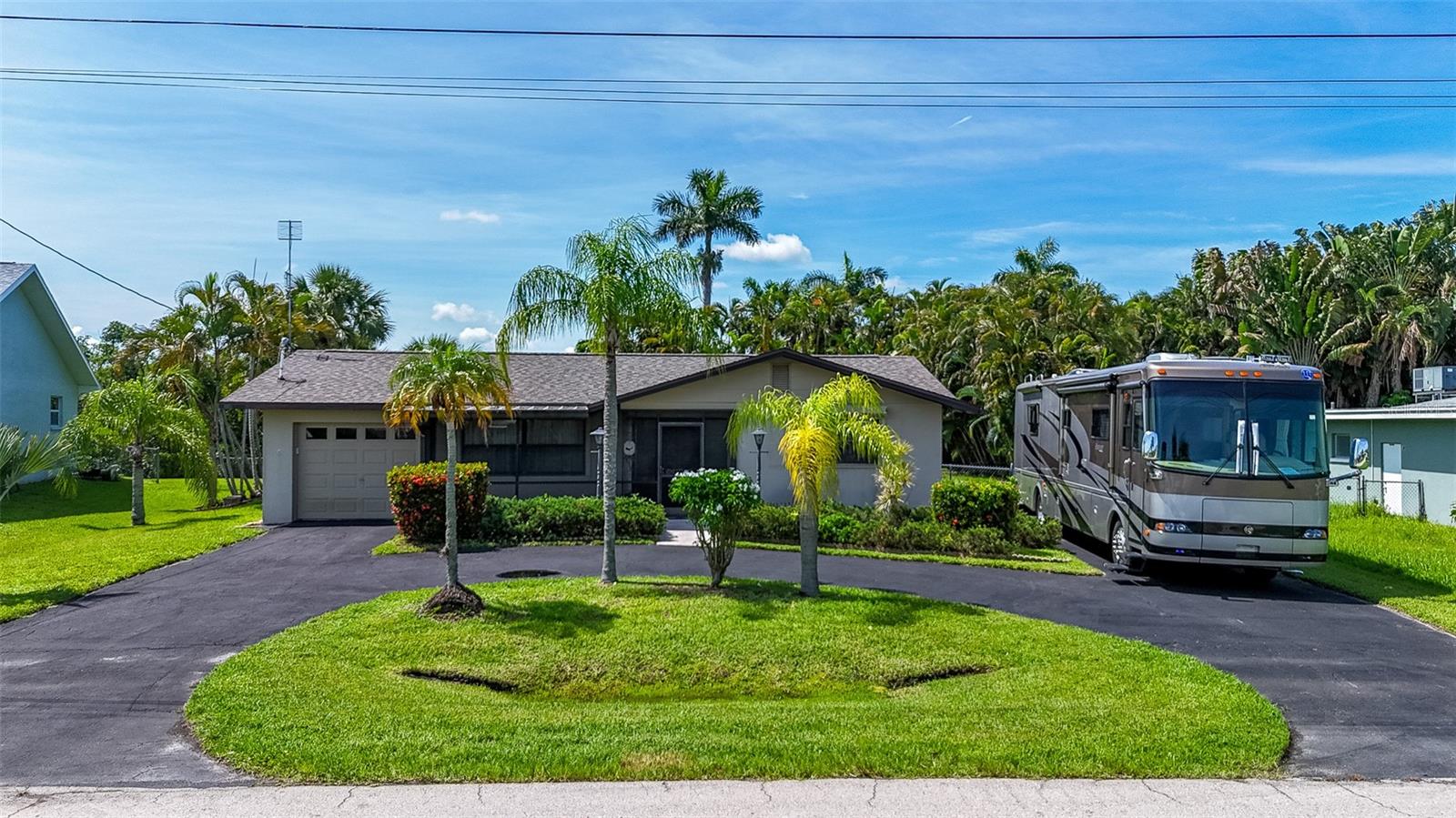 Centrally located off Moody Road.. easy commute to Cape Coral and downtown Fort Myers. The back yard welcomes you to the waterfront wonderland. Dock with a 7000 lb lift, room for a pool and one rear facing garage with full size garage door. New roof and gutters 2023. Drain field, septic and AC were updated in 2013. The handy roll down shutters were installed in 2012. Second garage door enters from the front for a total of 543 sq feet of garage space. Motor home parking on the side of the home and a circle drive for easy day to day trips and company. Call today to schedule your tour by car or BOAT.
