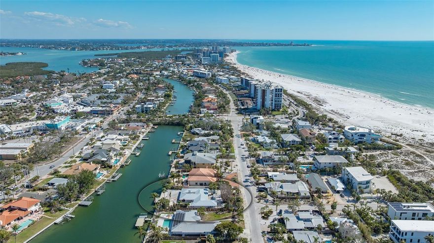 148 Polk represents extreme value. Note the two recent sold properties on South Polk, 259 S Polk and 117 S Polk. The on grade homes sold for $3,700,000 and 3,000,000 respectively.  148 Polk is 4,051 gross square foot with 4 bedrooms and 3 full baths and a 2 car garage. The house is the lowest priced, highest quality home site on the local Sarasota islands. The lot is a Rare DOUBLE lot (16,000 sq ft) that checks "ALL THE BOXES". It's one of the very few properties that offers: a location only steps to the sands of Lido Beach, steps to the shops and restaurants of St Armand's Circle, is waterfront with a big bayou view and is a double lot. The lot also comes with a new seawall, concrete cap and dock. From this one-of-a-kind lot, you can design a home with a large rooftop terrace, and you will enjoy views of the Gulf of Mexico adding tremendous value to the home. HOUSE WAS FLOODED IN OCTOBER 2024. Sold AS IS only.