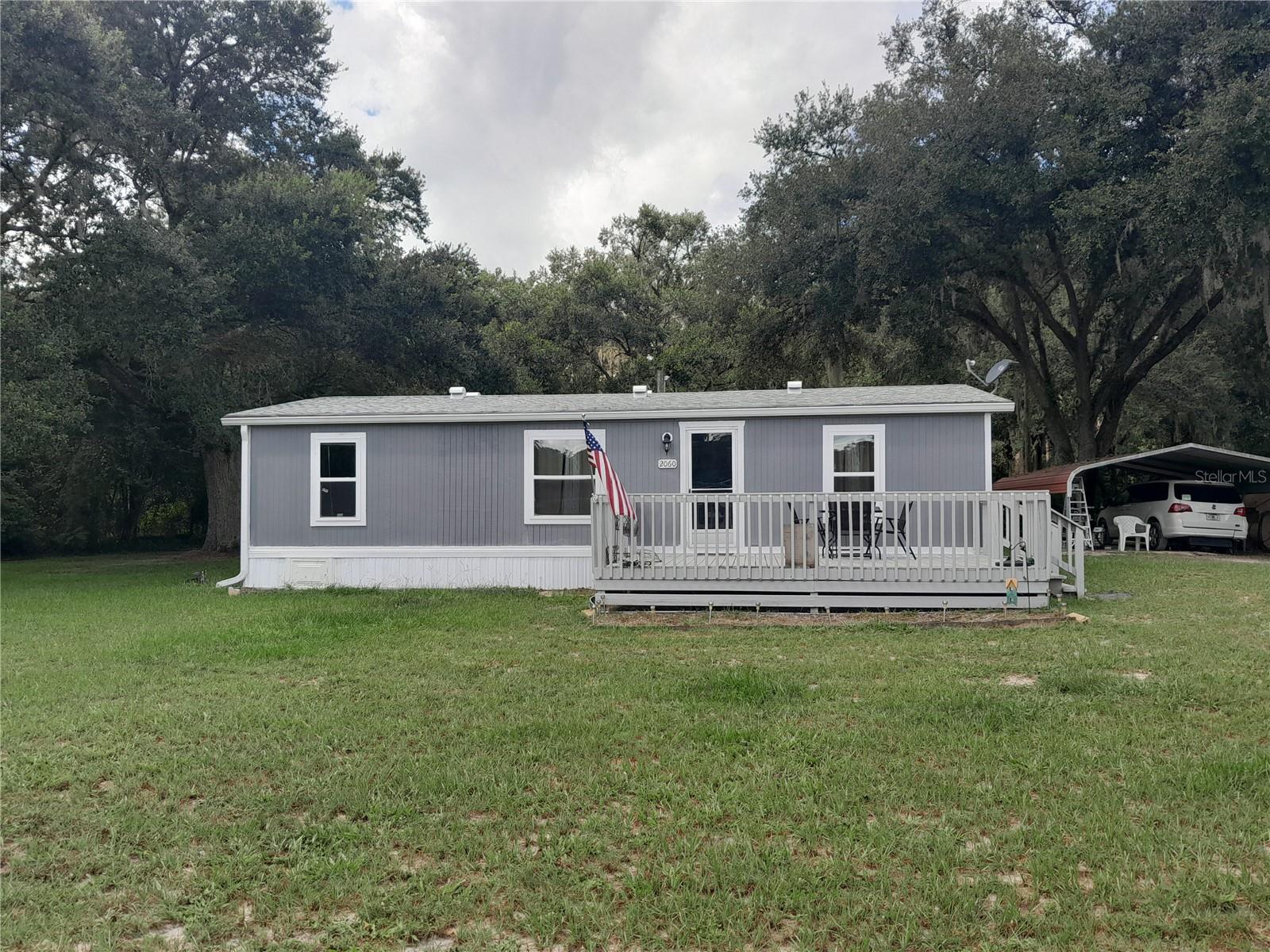 CHARMING COUNTRY MOBILE RECENTLY UPGRADED!! 3 bedrooms & 2 bathrooms, the master bath has a brand new shower with beautiful tiles and a seat for grooming. The master bath, 2nd bathroom, hallway, dinning room, kitchen and back entrance has new Smart core ceramic tile flooring that is water stain, dent and scratch resistant, and comes with a lifetime warranty. The master bathroom also has a new toilet. Living room is open concept with the dining room and kitchen area. There is a New Water Heater/HVAC System/New Roof, New Windows, New Skirting and New Updated Plumbing.
No flood zone, high and dry and no HOA. 1 acre with fencing all around. Beautiful trees and lawn maintain a great place to play and bar b q. Carport and shed that houses the Washer and Dryer and has plenty of space for storage. Perfect spot to retire with a couple horses, chickens, a garden etc. Enjoy sitting on your front porch with a cocktail at night and watching the sun set, or begin your day with a cup of coffee as the sun rises. Call for your appointment today. Do your own due diligence for measurements. SECO is your electric company.