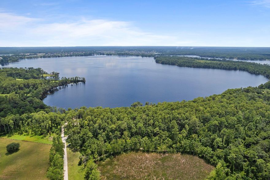 Nestled in the serene community of Pickett Downs, this BEAUTIFUL 4-bedroom, 2-bath SPLIT plan, SCREENED POOL home offers the perfect combination of privacy and comfort. Situated on just over 2 acres with no rear neighbors, you’ll enjoy peaceful surroundings and ample space to spread out and take advantage of the PRIVATE access to PRISTINE Lake Pickett, a SKIABLE lake perfect for water sports. The home features a METAL roof (installed in 2017), ensuring durability and long-term protection. NEW AC was installed in 2023, and the water heater is NEW as well, providing peace of mind with modern, efficient systems. NEW WINDOWS in 2019, pool pump is only 3 years old too. Inside, the home has been freshly painted, both inside and out, and boasts UPDATED kitchens and baths for a contemporary feel. Enginered hardwood flooring and plantation shutters add to the updates! While additional storage space is available in the form of a versatile WORKSHOP. Perfect for a hobbyist or anyone needing extra room for tools and equipment. This horse friendly subdivision allows for 1 horse per acre with a bridal path in the neighborhood.  This home offers a perfect blend of convenience, privacy, and access to the great outdoors. Seminole County Schools, 45 minutes to the beach and Kennedy Space Center. The home is ready for its new owners!!