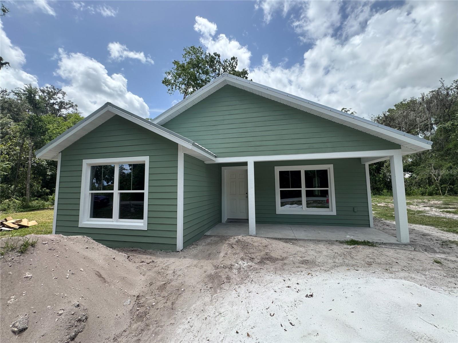 One or more photo(s) has been virtually staged. Under Construction. !!Brand New & Under Construction!! Welcome to your future home in peaceful Lake Panasoffkee—a beautifully designed 3-bedroom, 2-bathroom single-family residence set on an oversized 0.34-acre lot with a lovely view of Lake Panasoffkee! Featuring 1,561 square feet of carefully planned living space, this home offers the perfect blend of rural tranquility and modern comfort. A similar model is for sale right next door, offering additional options for families or friends looking to live nearby! Once completed, every inch will showcase quality craftsmanship and thoughtful design. You’ll love the stucco lap siding, durable metal roof, and high-end finishes throughout—including handmade wood cabinetry, granite countertops, and elegant tiled shower walls. Step inside to a bright, open-concept floor plan that fills with natural light and flows effortlessly for everyday living or entertaining. The spacious kitchen opens to the main living and dining areas, creating a warm, welcoming space for family and friends. But the real magic awaits outdoors—enjoy a freshly sodded yard, a private fenced-in space, and gorgeous views of Lake Panasoffkee just beyond your doorstep. Whether you're sipping your morning coffee or winding down at sunset, the calming lake vista adds a daily dose of serenity. Located just seconds from the lake, you’ll have easy access to world-class fishing, boating, and scenic outdoor adventures, while staying close to local shops, dining, and essential services. This is more than just a home; it’s your private escape. Construction is already underway—don’t miss the chance to own this stunning new build with a lake view in the heart of Florida living. Secure it now before it's gone! **Photos shown are of a completed home of the same model to give you a true sense of the style and finishes this beautiful property will feel once construction is complete.**