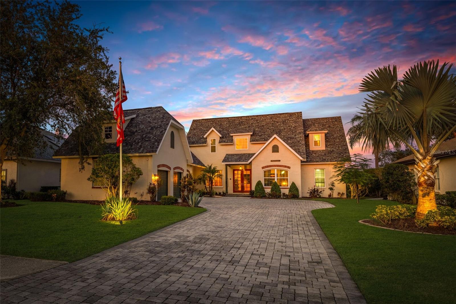 This exceptional chalet-style home in Cory Lake Isle offers luxurious living with stunning, one-of-a-kind features. The pavered driveway leads you to a formal double-door entry, where a peaceful fountain sets the tone for the tranquility within. This custom built home greets you with a spacious great room, soaring two-story ceilings and expansive transom windows, bringing the outdoors in and framing the home’s deep-water views. The sparkling pool and spa are heated for 12 months of enjoyment. Lake views stretch in both directions with conservation beyond, feels like you are surrounded by nature. Inside, mahogany wood flooring and crown molding flows seamlessly throughout. The gas fireplace is the perfect spot for holiday decorations and cozy evenings spent looking over the stunning lake views. New accordion-style sliders open to the vast lanai, which features multiple areas for enjoying the Florida sunshine. From casual meals to the gazebo, this outdoor space is designed for seamless indoor-outdoor living. Prefer dining al fresco? The dining area and summer kitchen are perfect for meals surrounded by natural beauty. The stately elm tree stands guard over this beautiful home. Formal living and dining rooms are in the front of the home with the gourmet kitchen nearby. Designer sage green cabinetry with multiple glass doors, gas stove, top of the line appliances, large island with vegetable sink, cookbook shelves, decorative bins and exotic marble countertops make this a truly special kitchen. Cozy breakfast nook looks over the lanai and pool area. The first-floor primary bedroom offers French doors leading to the lanai, while the ensuite bathroom is a true retreat, complete with double sinks, a walk-in shower, a jetted tub, and a built-in vanity. On the opposite side of the home, two generously sized guest bedrooms with oversized closets share an additional bathroom. Upstairs is an oversized second primary bedroom and ensuite bathroom. French doors open to a private balcony overlooking the lake, the perfect bedroom for the princess in the family. Across the catwalk there is another large bedroom AND additional versatile space which could be used as a bonus room, nursery, office, or extra bedroom. Large laundry with cabinets and shelves. The extended three-car garage is both wider and deeper than a typical garage and provides ample storage space, ensuring that everything has a place in this thoughtfully designed home. This light and bright home is perfect for sun-loving homeowners. It combines exceptional craftsmanship with the beauty of Florida living, offering the opportunity to enjoy the Florida sunshine and the lake views at every turn. Cory Lake Isle Beach Club has a massive resort-style pool and slide, boat dock, workout facilities, gathering room and pool cabana, tennis and basketball courts, roller hockey and sports fields as well as a 3-mile perimeter around Cory Lake, for after dinner walks. ROOF IS TWO YEARS OLD. Front windows replaced and exterior has been recently painted. This gated community has 24/7 manned security, two gates and easy access to I75, I275, downtown Tampa, Tampa International Airport, Moffitt Cancer, University of South Florida, Haley VA Hospital. Three hospitals within a few miles and innumerable restaurants, entertainment, and malls. The Cory Lake lifestyle is unlike any other community and is frequently called Paradise in New Tampa. If you want to love where you live, make sure this home is on your list.