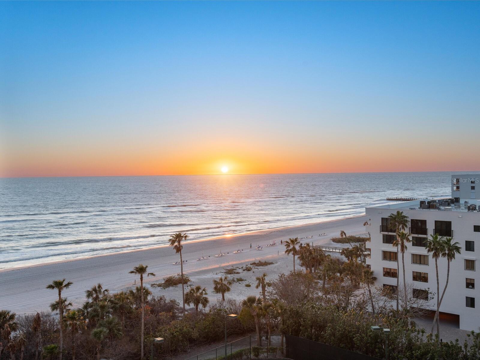 Introducing an exceptional beachfront residence that redefines luxury living on Longboat Key, offering panoramic seventh-floor views that span from the Gulf of Mexico to Sarasota Bay. This beautifully furnished three-bedroom, four-bath retreat encompasses over 3,000 square feet under air and delivers an unparalleled coastal lifestyle. The expansive great room is elegant and versatile, featuring a built-in library display and direct access to the main balcony, ideal for entertaining or quiet relaxation. The gourmet kitchen is a chef’s delight, complete with white cabinetry, stone countertops, a center island, a new refrigerator and a cozy breakfast nook with captivating views of the beach. The primary suite is a private sanctuary, offering a spacious walk-in closet, dual baths, and a secluded beachfront terrace for peaceful morning coffee or stunning sunsets. On the opposite side of the residence, a deluxe en-suite guest room with a large walk-in closet awaits, along with a flexible third bedroom, office or den with a full bath conveniently across the hall. A semi-private elevator delivers you directly to your home and connects you to the resort-style amenities that make Water Club one of Longboat Key’s most prestigious addresses. Impeccable concierge service, an 18,000-square-foot clubhouse with fitness center, spa, library, game room and ballroom, a heated beachfront pool and spa, fire pit courtyard and Har-Tru tennis courts, all with 24-hour gated security for ultimate peace of mind. On 16 acres of lush tropical landscaping and boasting 680 feet of private beachfront, Water Club offers an exceptional blend of privacy, luxury and community. Pet-friendly and ideally located, you’re just minutes from world-class golf, boating, boutiques, dining and the cultural heartbeat of downtown Sarasota. Experience the pinnacle of coastal elegance, where every day is a celebration of Longboat Key’s natural beauty and refined lifestyle.