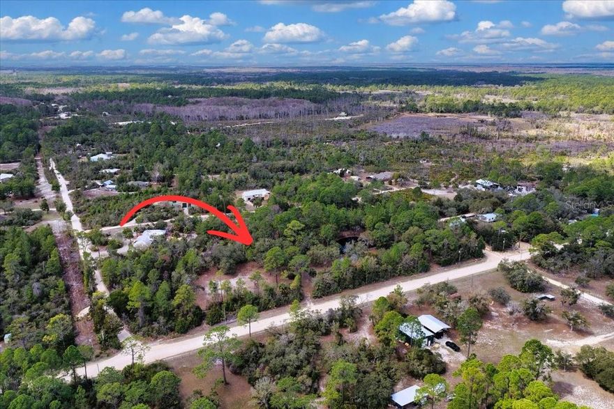 This property just feels like Old Florida. Located just a few miles outside of Cedar Key, this amazing 2.75 acre lot is ready for your weekend adventure or forever home. Approximately 1 acre has been cleared and is ready for building, while the remainder has been left with beautiful live oaks and palmettos creating a beautiful shaded canopy for relaxation and recreation. 
A picturesque pond with a dock invites you to slow down and enjoy the view. Electric service with a 30 amp RV hook up is already in place, giving you a head start while you plan and build. The property also features a 20’ x 20’ metal building for storage and a 15’ x 30’ shed that offers additional space for equipment, parking or the potential for an outdoor kitchen or gathering area. Fully fenced for privacy and security. Bring your RV, build your dream home or create the perfect weekend getaway. With the natural beauty, privacy and improvements already in place, this property offers endless possibilities. Spend your days fishing, kayaking, and exploring nearby Cedar Key, then return to the quiet of your own private retreat. If you’ve been searching for a peaceful slice of Old Florida with room to relax and enjoy nature, this is it. (RV & boat do not convey)