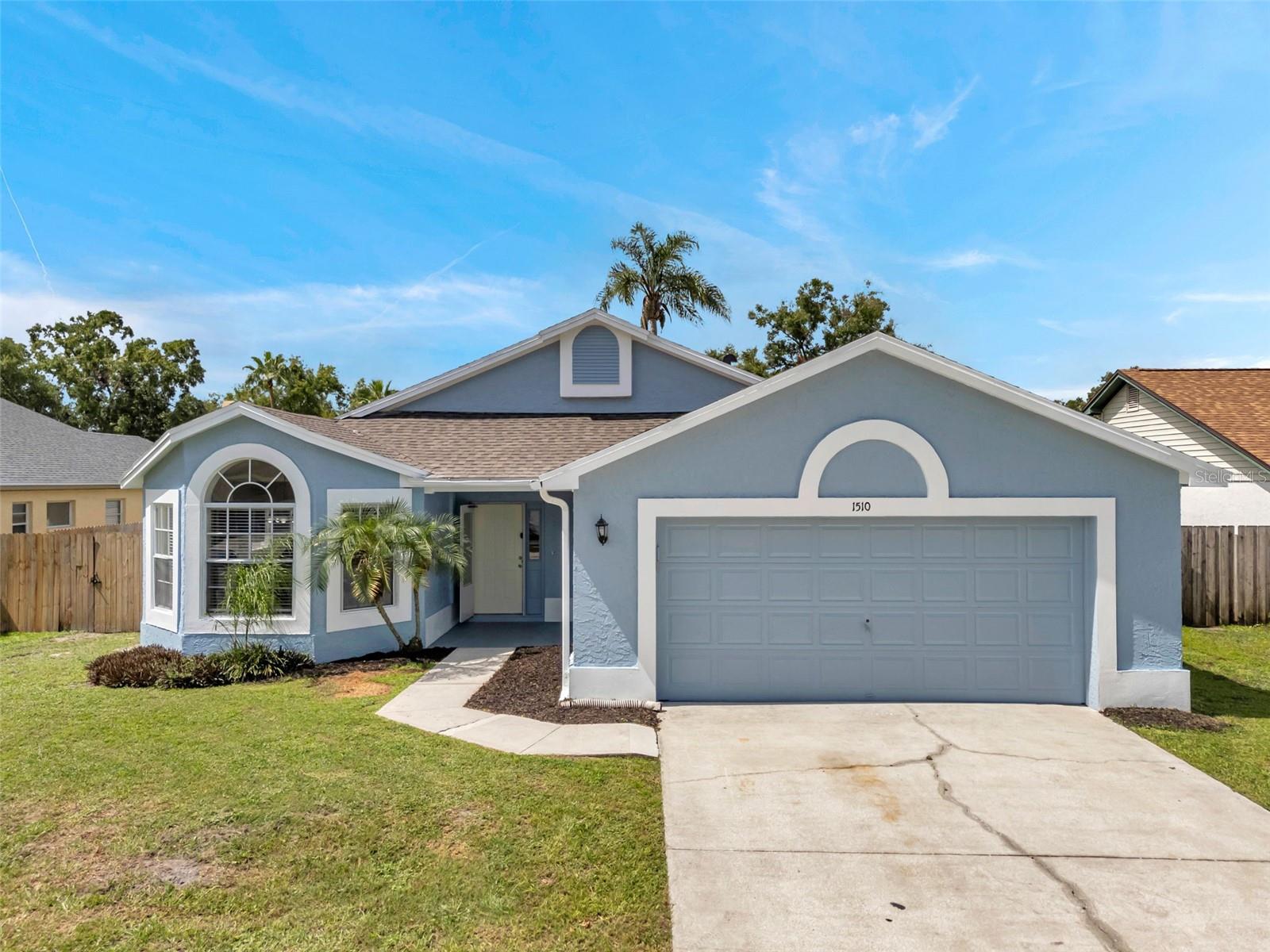 Welcome home to this spacious four-bedroom, two-bath residence in the Providence Lakes Subdivision. This move-in ready home features recent updates, including fresh interior and exterior paint, new luxury vinyl plank flooring in the main areas, new carpeting in the bedrooms, updated bathrooms with new tile surrounds, and a brand-new roof (2025). The well-designed floor plan offers a large, open family room with soaring ceilings and sliding glass doors, a separate dining room, and a kitchen with a breakfast nook and bay window. The bedrooms are arranged in a three-way split layout. The primary suite is located at the back right of the home and features a sliding glass door to the patio, an en-suite bathroom with a spacious closet, and a dual-sink vanity. Two secondary bedrooms are situated at the rear left side, while the fourth bedroom is at the front of the home with built-in shelving—ideal for a home office. Additional features include an inside laundry room, a kitchen with a pantry closet and breakfast bar, granite countertops, ceiling fans in every room, a fenced yard, and a large screened, covered patio. This home is centrally located in Brandon, offering easy access to major roads, shopping, dining, schools, hospitals, entertainment, and the Brandon Town Center Mall. The Providence Lakes community boasts a low annual HOA fee, no CDD fees, and amenities such as a playground and park with picnic tables. Schedule your private tour today!