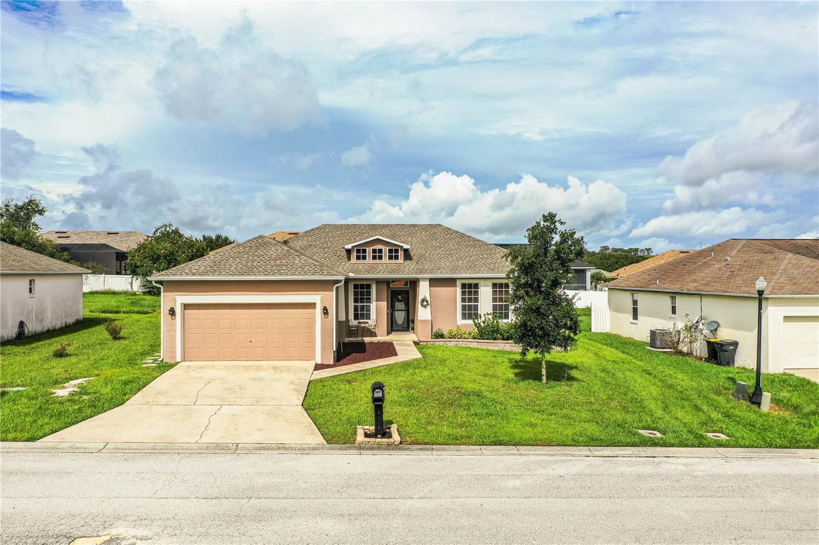 Welcome to this beautifully updated and move-in ready 3-bedroom, 2-bathroom home with a versatile den/office, located in the highly desirable Beverly Rise community of South Lakeland. From the moment you arrive, this home will impress with its charming curb appeal, freshly painted exterior, and thoughtful upgrades throughout. A brand-new roof was installed in July 2025 and comes with a transferable warranty, just one of many recent enhancements. Step outside and enjoy a spacious, fully fenced backyard complete with gates on both sides (including a convenient double gate), a large patio deck with a sail shade cover, a cozy firepit area, and a 2-car garage with built-in storage cabinets. Whether you're relaxing or entertaining, the outdoor space offers comfort and flexibility. Inside, the home continues to shine. You’ll be welcomed by brand-new waterproof laminate flooring in all common areas, a freshly painted interior, stylish staging and décor, and a sliding glass door that’s both double-paned and tinted for energy efficiency and privacy. The kitchen is a cook’s dream—recently updated with granite countertops, stainless steel appliances, tile backsplash, solid wood soft-close cabinets and drawers, under- and over-cabinet lighting, and a closet pantry with additional custom storage including pull-out drawers. A breakfast bar overlooks the sink area, and a bright dinette space sits just off the kitchen, in addition to a separate formal dining room. The living room is spacious and inviting, perfect for large furnishings and gatherings, and enjoys plenty of natural light from the tinted, double-paned sliding door. The primary bedroom offers comfort and elegance with laminate flooring, tasteful décor, and a large walk-in closet featuring custom shelving, drawers, and hanging space. The en-suite bathroom is fully renovated with a dual-sink granite vanity, updated mirrors and lighting, and an impressive wraparound tiled shower that’s sure to wow. The home’s split floor plan places the two additional bedrooms on the opposite side of the home, each with carpet, built-in closets, and crown molding. They share a beautifully updated hall bath with a tiled tub/shower combo and modern vanity. The flex room offers endless possibilities; it’s ideal for a home office, den, guest room, or playroom. All furnishings and décor is available for purchase separately from the home itself. Additional upgrades and features include a newer A/C air handler, new ceiling fans throughout, interior laundry room, new hot water heater, alarm system (ADT ready), and much more! This home truly has it all; style, functionality, and a fantastic location. Easy to show and ready for its next owner so schedule your private tour today!