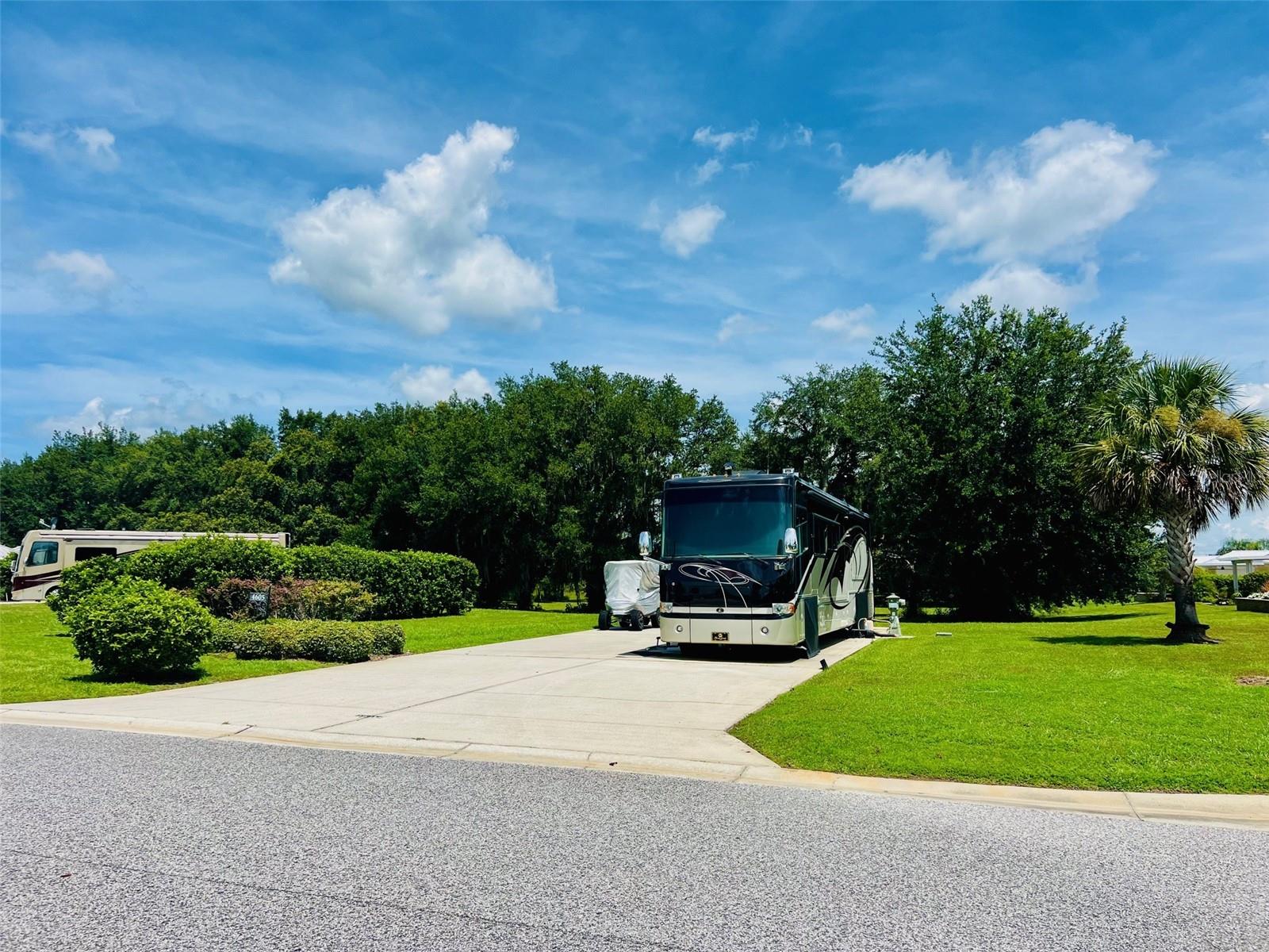 Welcome to Lot 60, a truly rare opportunity at Florida Grande Motor Coach Resort. Spanning an
impressive 12,235 square feet—nearly two and a half times the size of a standard lot—this is the
ultimate space to create your private retreat. The expansive 26’x76’ concrete pad easily
accommodates even the largest motorhomes, with water, sewer, and 50-amp electric service
ready at the pedestal. Nestled against a peaceful backdrop of the nature preserve, you’ll enjoy
both privacy and natural beauty right from your patio.
While the lot itself is spectacular, it’s the sense of community that sets Florida Grande apart from
any other resort. Here, neighbors quickly become friends, and every arrival feels like coming
home. The recently updated clubhouse features a beautifully renovated Grande Room for
gatherings and events, along with a resurfaced pool and pool deck perfect for relaxing under the
Florida sunshine. Near the resort’s exciting new expansion area, you’ll find eight brand new
pickleball courts that have become a favorite gathering spot for residents and guests alike. An
abundance of regularly scheduled activities and special events keep the calendar full all season
long, making it easy to connect, unwind, and create lasting memories together.
With lots selling fast this summer, this is your chance to secure an oversized property in one of
Central Florida’s most welcoming motor coach communities. Ideally located just an hour from
Tampa, Orlando, and Ocala, Florida Grande is the perfect home base for exploration and
camaraderie. Welcome home to a place where you’re never just passing through—you truly
belong.