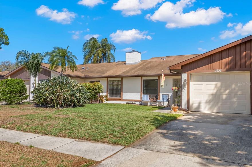 Updated Villa in Oldsmar with Low HOA, 2024 HVAC, updated kitchen and baths, Hurricane impact window and sliders & heated Community Pool. Welcome to 2020 Dover Ct in Oldsmar, Florida—an updated 2-bedroom, 2-bath villa with a 1-car garage, ideally positioned on a quiet cul-de-sac in one of Oldsmar’s most convenient locations. Offering 1,143 square feet of thoughtfully designed living space, this home blends comfort, functionality, and low-maintenance Florida living. Recent updates provide peace of mind, including a 2024 A/C system, new duct work 2022, hurricane-rated sliders 2022, updated hurricane-rated windows 2019, garage door 2023, and beautifully refreshed kitchen and flooring with new tile extending through the hallway and into the bathrooms, updated bathrooms. Step inside through the welcoming foyer to find a light and bright interior with volume ceilings and a spacious great room with Luxury Vinyl Plank flooring is centered around a charming wood-burning fireplace—perfect for cozy Florida evenings. The updated eat-in kitchen is designed for both everyday living and entertaining, featuring abundant counter space, a flat cooktop range, stainless steel refrigerator, breakfast bar, large cabinet pantry, and the added convenience of an under-counter washer and dryer. The split-bedroom layout offers privacy, with the secondary bedroom and full bath located near the front of the home, while the primary suite is tucked away and features sliding glass doors leading to the Florida room, a large linen closet, and an updated en-suite bath with a step-in shower. Enjoy relaxing mornings or evening breezes on your Florida room that overlooking your  backyard—ideal for enjoying Florida’s year-round outdoor lifestyle. With low HOA fees of just $160/month, residents enjoy true maintenance-free living including lawn care, community pool access, annual tree trimming, pressure washing of sidewalks once a year, maintenance of the rear fence behind the villa, and reclaimed water for irrigation—saving you both time and money while keeping the community beautifully maintained. Location is everything, and this home delivers—just minutes from shopping, dining, movie theaters, hospitals, medical facilities and everyday conveniences, with easy access to Tampa Road, US-19, and McMullen Booth Road for quick commutes to Tampa, Clearwater, and St. Petersburg. Outdoor enthusiasts will appreciate nearby parks, trails, and waterfront areas, including Upper Tampa Bay Park, the Oldsmar Trail, and quick access to the Courtney Campbell Causeway. World-famous Gulf beaches, Tampa International Airport, and St. Pete-Clearwater Airport are all within an easy drive. This is your opportunity to own an updated villa in Oldsmar with low maintenance, strong value, and a prime location—schedule your private showing today and start living the Florida lifestyle.