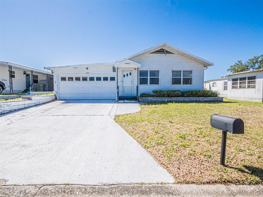 Bring your vision and unlock the potential of this unique manufactured home in Coachwood Colony, a desirable 55+ community!  This spacious 2-bedroom, 2-bath home offers a layout you don't often find, featuring an expansive living area perfect for entertaining or relaxing in comfort.  One of the standout features is the attached 2-car garage, complete with a dedicated laundry room, workshop and separate office space - ideal for hobbies, storage or working from home.  An added attic space provides even more room for storage, making this home as functional as it is versatile.  Enjoy the Florida lifestyle from you lanai, offering a great space to unwind or host guests.  While the home does need some TLC, it presents a fantastic opportunity to customize and add value, with solid bones and flexible layout ready for your personal touch.