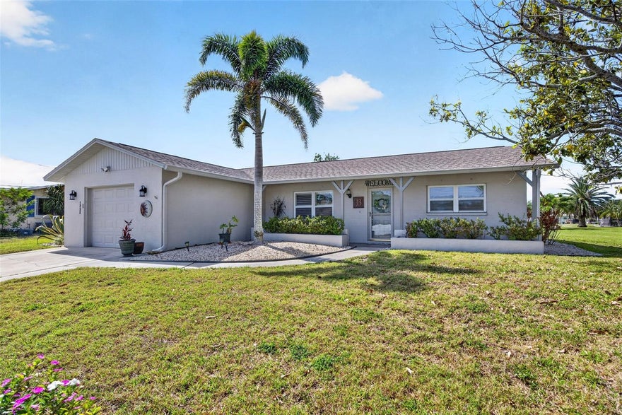FURNISHED! CHARMING 2 BEDROOM, 2 BATH, 1-CAR GARAGE, LAKEFRONT HOME offers the perfect blend of comfort and convenience. Nice curb appeal with mature landscaping and a shaded front porch. Featuring 1,268 square feet of living space with natural light, an open layout, and tile flooring throughout the formal living, kitchen, and dining areas. As you step inside, you're welcomed into the living room, which flows seamlessly into the kitchen featuring wood cabinetry, solid surface countertops, and a tile backsplash. Adjacent to the kitchen, a cozy dinette area offers the perfect spot for casual meals. Beyond the kitchen and dining area, the Florida room invites you to relax while enjoying serene water views. The primary bedroom includes a large walk-in closet and a private ensuite bathroom with a walk-in tile shower. Split floor plan provides guests with plenty of privacy with an additional bedroom and full guest bath perfect for family or visitors. The outdoor area features a seating area overlooking the backyard and serene water views of a lake with a dock, perfect for fishing or relaxing. The spacious yard also offers plenty of room to add a future pool, making it an ideal space for outdoor enjoyment. Situated on a quiet street, this home offers a peaceful setting while remaining conveniently close to shopping, dining, and entertainment. Englewood is a highly desirable community, and this home won't last long! You'll find world-class fishing, numerous golf courses close by, parks, Manasota Key Beach, boating and a wide variety of dining and shopping! Don't miss this opportunity! Schedule your private showing today!
