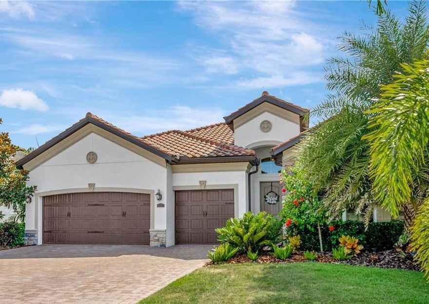 Stunning waterfront home in Arbor Grande. Welcome to this beautifully appointed Tivoli model home built in 2019, offering an ideal blend of comfort, elegance and modern design. On a premium cul-de-sac waterfront lot offering exceptional privacy and tranquil views surrounded by mature trees and lush landscapes. Enjoy a serene setting with no through traffic and proximity to Bob Gardner Park, a one-mile linear park featuring dog parks, paved nature trails, a gravity swing, playground, disc golf, soccer and baseball fields, and picnic pavilions. Inside the home, you’ll find a newly painted, spacious open-concept floor plan with 10-foot ceilings, crown moldings, tray ceilings, and plank tile flooring in a neutral greige tone throughout the main living areas. A wall of sliding glass doors seamlessly connects the great room to the screened lanai, creating an indoor-outdoor flow for entertaining. The lanai features a sparkling saltwater pool, heated spa, outdoor shower, a fully equipped outdoor kitchen with a stainless-steel gas grill and vent, refrigerator and LED color-changing pool cage lighting. The chef’s kitchen boasts white cabinetry, granite countertops with an expansive prep island, a suite of stainless appliances, including a gas cooktop, built-in oven and microwave, and a new dishwasher (October 2025). The eat-in dining area is conveniently off the kitchen, and a breakfast bar provides additional seating for casual dining. The flex space off the foyer can serve as a formal dining room or home office. The home offers four bedrooms and three full baths, including a spacious primary suite with tray ceiling and abundant natural light. The primary bedroom en-suite bath features a double sink vanity, large soaking tub and walk-in shower with beautiful neutral walls tiles and a seamless glass shower door. Bedroom 4 includes a Murphy bed and luxury vinyl plank flooring, ideal for guests or a home office. Bedroom 2 features a wood accent wall, and three bedrooms have new carpets, October 2025. Additional features include a laundry room off the kitchen with new washer and dryer included. Oversized three-car garage with Wi-Fi compatible openers, NEMA 14-50 wall charger for electric vehicles and wall organization racks. The stone paver driveway and pool deck, exterior stone accent walls and tile roof give this home a custom look. Residents of Arbor Grande enjoy many amenities within their gated community, including a lifestyle director, heated resort-style pool with lap lanes and heated spa, clubhouse with kitchen and gathering room, a fitness center, sand volleyball and bocce ball courts, community park and dog park, walking paths, and yard maintenance is included in HOA fees. See this resort-style living in one of the area’s desirable communities. It could be just what you have been looking for!