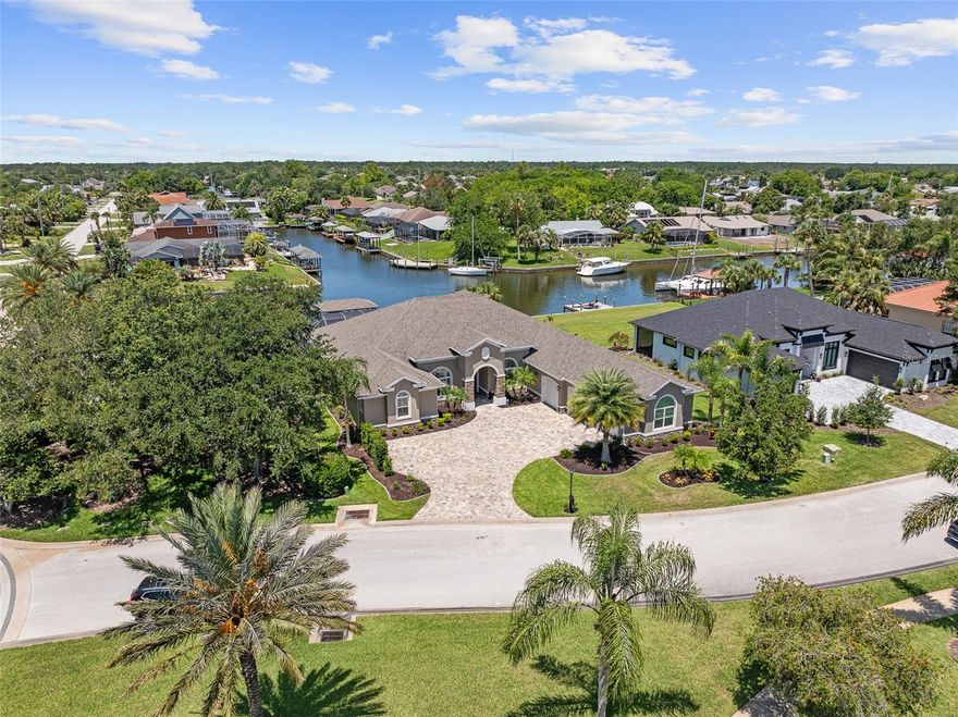 Luxurious Waterfront Living nestled in the prestigious, gated community of The Sanctuary, this stunning custom-built home (2021) seamlessly blends refined luxury with everyday functionality and exceptional saltwater canal access. Spanning 4,225 square feet, the residence is thoughtfully designed to capture both comfort and elegance in every detail. The expansive primary suite offers a tranquil retreat with custom closets and a spa-inspired ensuite featuring designer tile and refined finishes. Throughout the home, soaring ceilings enhance the open, airy atmosphere—10 feet in the bedrooms, 12 feet in the main living areas, and up to 13 feet in tray ceilings. Entertain with ease in the chef’s kitchen, complete with 42-inch white shaker cabinetry, a large walk-in pantry, and generous counter space for hosting. The home includes four spacious bedrooms with ensuite baths, two half baths (including a dedicated pool bath), and a flexible in-law suite or flex space—ideal for multi-generational living or guest privacy. Interior features include real wood flooring, plantation shutters, electric blinds, a gas fireplace with multi-speed fan, central sound system, central vacuum, and thoughtfully placed floor outlets for convenience. The laundry room is equipped with a washer and gas dryer. Step outside to your private waterfront oasis, where outdoor living takes center stage. Enjoy a chlorine pool, covered boathouse, 222-volt power at the dock, and a 10,000 lb boat lift. The property is pre-wired for a portable generator with a 50-amp plug—perfect for peace of mind. Note: Fabric valances do not convey.This is a rare opportunity to own a fully appointed, meticulously maintained waterfront retreat in one of Palm Coast’s most exclusive communities. A true gem for those seeking elevated coastal living.