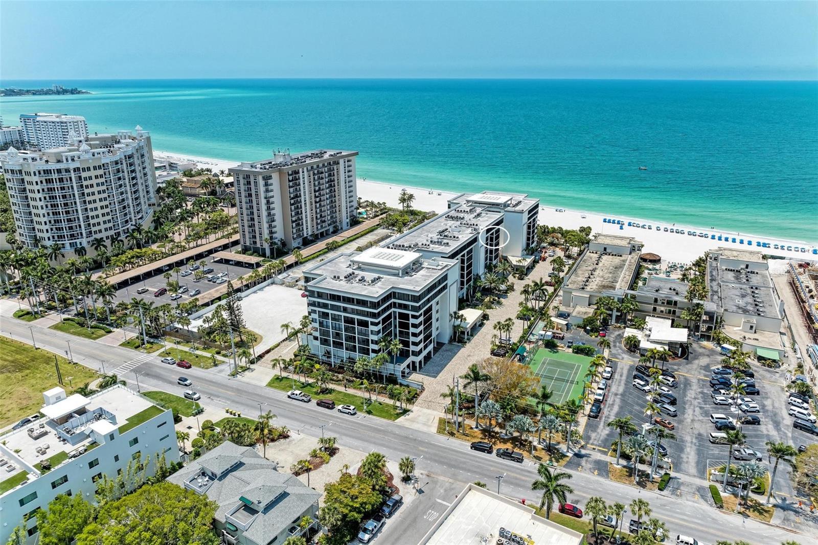 One or more photo(s) has been virtually staged. Looking to live the beach life? Discover luxury beachfront living at its finest in this spacious 4th floor condo perched on the shores of Lido Beach. Enjoy the views of the beautiful sunsets over the beach and Gulf of Mexico in your expansive lanai. **THIS PROPERTY QUALIFIES FOR A 1% LENDER INCENTIVE IF USING PREFERRED LENDER. INQUIRE FOR MORE DETAILS.** The combined living room and dining area is great for entertaining. The primary suite offers a private oasis for relaxation with a well appointed en suite bathroom. The split floor plan is perfect for when you have guests with their bedroom and bathroom on the other side of the condo. The Lido Surf & Sand community provides exceptional amenities including a beachfront pool and spa, shuffleboard, BBQ grills, and a fitness center. Socialize with neighbors in the gathering room or take advantage of your covered parking spot. You can watch the waves and beachgoers while relaxing in the pool. There is a gate that goes right to the beach, from the pool, if you decide to take a dip in the ocean. The location can't be beat! Just a few minutes from fine dining and shopping at St Armands Circle and then over the Ringling Bridge to downtown. You are also a couple of minutes away from Ted Sperling Park where you can kayak or paddle board through the mangroves while enjoying wildlife. Don't miss this opportunity to create your own coastal paradise!