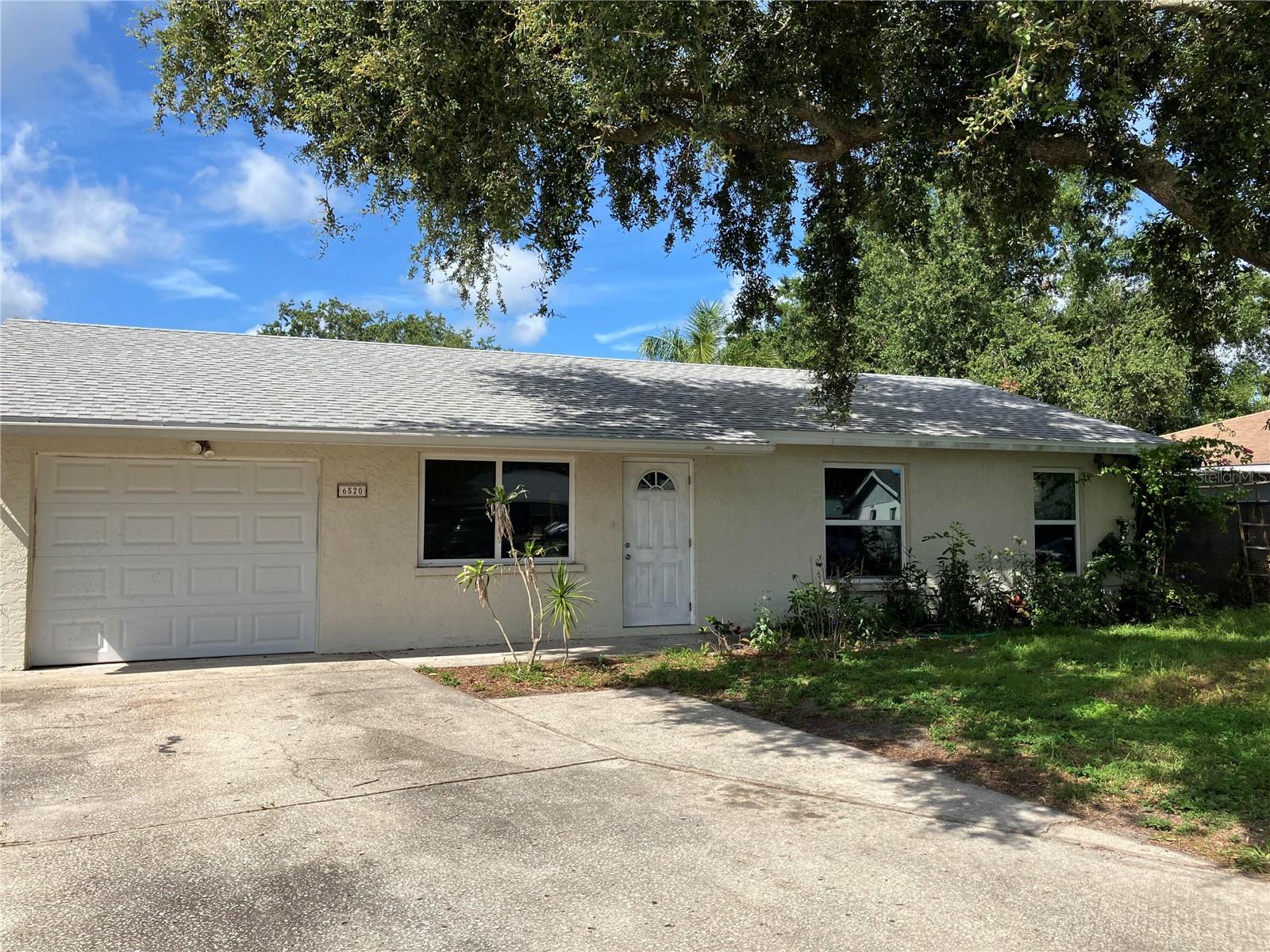 This 3 bedroom home has been updated with a beautiful kitchen, granite counter tops, stainless steel appliances and wood cabinets. Ceramic tile continues through living room, hallway, and first bedroom. Italian tile recently installed in second bedroom and marble tile in master bedroom. Newer tile in bathroom shower. Fully Fenced in backyard tropical oasis. Lush green clumping bamboo privacy hedge, dwarf buddha bamboos, raised bed gardens, passion fruit vines, key lime, calamondin, and banana tree. Large concrete patio just outside the back door has been expanded and permitted for a 1 story addition or sunroom in 2024. New roof placed in June 2025. Garage door new in 2019. Upgraded 50 gallon electric water heater in 2024. Home is on a private Cul De Sac. Easy access to I-75 for easy commutes North or South. Shopping, Restaurants and Tom Bennett Park nearby. NO HOA OR CDD FEES
