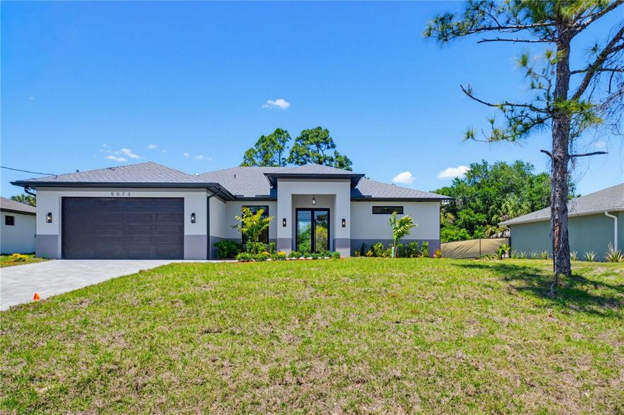Step into luxury at 5097 Hightower Road in North Port, Florida, where thoughtful design and premium finishes come together to create the perfect Southwest Florida lifestyle. As you arrive, you’re welcomed by a beautiful paver driveway and elegant French doors that make a stunning first impression before you even step inside.

Once through the front entrance, the home immediately opens up with soaring 12-foot ceilings and detailed tray ceilings throughout the main living areas, creating a bright and spacious atmosphere that feels both warm and sophisticated. Oversized hurricane impact windows allow natural light to pour throughout the home while providing peace of mind year-round.

At the center of the home is a beautifully designed chef’s kitchen featuring a dramatic waterfall island, double-stacked cabinetry, and high-end finishes that blend style with functionality. Whether you’re entertaining guests or enjoying a quiet night at home, this open-concept layout was built to bring people together.

Just off the main living space, you’ll find a dedicated office/den area that offers the flexibility today’s buyers are searching for — perfect for working from home, a playroom, fitness space, or additional lounge area.

The home continues to impress as you step out onto the tiled lanai, creating the ideal outdoor space to relax and enjoy Florida living. Even the garage was designed with quality in mind, featuring sleek epoxy-coated floors that add both durability and a polished finish.

Built by PadPath, this 3-bedroom, 2-bathroom home is packed with the affordable luxury upgrades buyers across Southwest Florida are looking for. Modern design, premium craftsmanship, and incredible value all come together in one exceptional North Port home.