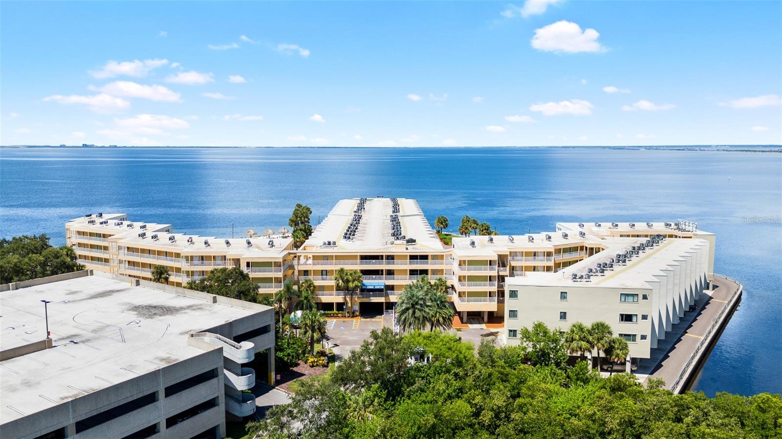 An exceptional opportunity to own one of only ten 2-bedroom, 2-bathroom condominiums in the highly desirable Sailport Waterfront Suites. Situated directly on Tampa Bay, this updated unit showcases stunning water views from the main living area and private balcony, offering a true waterfront lifestyle in the heart of Tampa. The condo has been thoughtfully updated with fresh interior paint, coastal-inspired décor, stylish furnishings, and a remodeled bathroom featuring a modern walk-in shower. Designed for comfort and convenience, this condo provides a turnkey experience for both owners and guests. Residents enjoy a resort-style setting with amenities that include a geothermal heated pool, sandy beach with volleyball court, outdoor fitness area, fire pit, charcoal grilling stations, meeting rooms, laundry facilities, and 24-hour gated security. The on-site waterfront restaurant and ship store add to the convenience of this all-inclusive community. Ideally located just minutes from Tampa International Airport, Ben T. Davis Beach, waterfront walking and biking trails, premier dining, shopping, and vibrant downtown Tampa. The world-renowned Gulf beaches are a short 20–30 minute drive away, making this an ideal base for both leisure and business. Whether you're seeking a primary residence, a vacation home, or a high-performing income property, this condo offers flexible ownership options. Owners can self-manage or utilize the on-site rental program. With a strong rental history and consistent demand, this is one of Tampa’s rare all-waterfront investment opportunities within city limits. Don't miss your chance to own a piece of paradise, schedule your private showing today