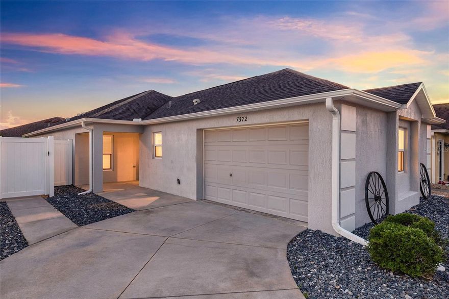 NO BOND! BETTER THAN NEW! Welcome to this Charlotte Patio Villa located in SOULLIERE VILLAS in The Village of CHATHAM! This beautifully maintained 3-bedroom, 2-bathroom home was built in 2016, features a 1.5 CAR GARAGE, and is move-in ready with NO BOND. Step inside to find LAMINATE FLOORING in the kitchen and bathrooms, with carpet in all three bedrooms and living areas. The kitchen is well appointed with DARK CROWNED CABINETRY, STAINLESS STEEL APPLIANCES, and RECESSED LIGHTING. The living room boasts VAULTED CEILINGS and SLIDING GLASS DOORS to the lanai, with an ADDITIONAL SLIDING GLASS DOOR from the dining area, making entertaining a breeze. The primary suite features a TRAY CEILING, WALK-IN CLOSET, and SLIDING DOORS TO THE LANAI. The en suite bathroom offers DARK CABINETRY, DUAL SINKS, and a WALK-IN SHOWER WITH BENCH. Both guest bedrooms offer BUILT-IN CLOSETS. The guest bathroom features DARK CABINETRY and a TILED TUB/SHOWER COMBO. A standout feature of this home is the INSIDE LAUNDRY ROOM WITH CUSTOM BUILT-INS, CABINET STORAGE, and a UTILITY SINK. The GLASS-ENCLOSED LANAI leads to a CONCRETE PATIO PAD that extends to the side of the home, all surrounded by LOW-MAINTENANCE ROCK LANDSCAPING.  Just an pleasant short walk from our neighborhood pool, and minutes to shopping and dining. Convenient to the First Responders Rec Center, also close to Nancy Lopez Legacy and Glenview Championship Country Clubs. Mulberry Grove Recreation Center, Calumet Grove Pool are close, as well as the Savannah Center. As owners here, you have access to executive and championship golf, fitness trails, the VA hospital, and the CR 42 corridor for shopping, dining, and everyday services!Golf cart or walk to rec center from back cart gate.