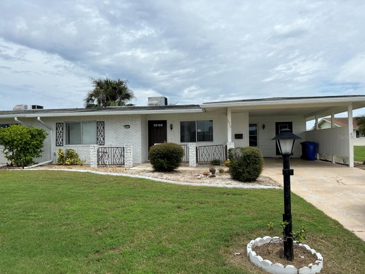 One or more photo(s) has been virtually staged. Villa in Sun City 2 bedroom 2 bathroom with an over sized garage. Open floorplan makes this property enjoyable along with a Florida room. Open kitchen with plenty of counter space. Inside laundry area and a utility room. Monthly HOA fee includes lawn Maintenace and water. Come enjoy this community with many activities... indoor and outdoor pools, clubhouses along with group activities for hobbies and fitness centers. This Villa property does adjoin the neighboring Villa that is also for sale in case a family or friends would like to have two properties next to each other.