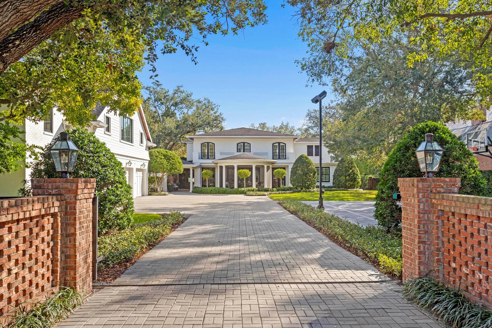 Nestled on the fifth hole of the prestigious Palma Ceia Golf Course, this exquisite property offers an exceptional living experience for those who appreciate sophistication & style. 1002 S. Frankland Road was renovated top to bottom by Soleil Design Build. The home, sitting on .72 acres, boasts an open-concept floor plan with spacious living areas, all designed with impeccable attention to detail. You will appreciate the thoughtful attention given to creating quality gathering spaces in the home. The stately entrance features an electronic gate for added security, brick-pavered drive, & courtyard with a 4 car garage. A grand set of double doors welcomes you into the home as you begin to notice & appreciate the meticulous details & elegant design. All spaces flow seamlessly out to the private backyard oasis with breathtaking views of the golf course. Large windows flood the interiors with natural light, creating a bright & inviting atmosphere. The oversized dining room, complete with chic wet bar & wine cellar, opens to a covered porch at the front of the home. The kitchen is grand in every way & will impress the most accomplished chef! Enjoy thick marble countertops/backsplash/surround, Wolf-Subzero appliances, double island/bar area, a sizable storage/pantry area, & a breakfast nook overlooking the spacious backyard. Open the sliding doors & prepare to be amazed at the beautifully landscaped grounds with views of the lush greens & fairways of Palma Ceia Golf Course. Take a dip in the saltwater pool, try a cold-plunge, practice your short game on the putting green, or roast marshmellows at the oversized firepit. The summer kitchen, complete with Green Egg, provides the perfect spot to entertain outdoors, sit around the bar, & watch the big game. Or, curl up next to the fireplace on your covered lanai. So many options for dining, lounging, or simply soaking in the serene surroundings. Off the kitchen is a sunken den with a fireplace, custom built-ins, textured brick walls, & a view of the course. On the south side of the home, you’ll find two guest bedrooms & a full bathroom. This area could serve as a home office, nanny/au pair quarters, or in-law suite. Also on the first floor is a home office with an amazing view of the course (naturally!), two half bathrooms, and the first floor laundry room. Upstairs, your luxurious primary suite awaits! Marble floors, painted concrete vanities, a steam shower and a soaking tub. The primary closet is generous in scope and size. Two guest bedrooms, each with walk-in closets and ensuite bathrooms, are also upstairs, as well as the second floor laundry room. Now let’s talk about fun! The area over the four-car garage is one-of-a-kind & provides flex space for you to perfect your golf swing with the golf simulator OR simply enjoy a movie in the theatre room. While you're at it, grab a quick workout in your private gym. This entertainment zone has a half bath, dishwasher, ice maker, beverage fridge, and storage. Your guests might never leave! The property has a full-house Generac generator and a smart-home system to manage lighting, security, doors, gate, temperature, media, and sound. Located in one of South Tampa’s most sought-after neighborhoods, 1002 S Frankland Rd offers not only an incredible living space but also access to top-rated schools, shopping, dining, and entertainment. Don’t miss the opportunity to enjoy luxury living at its finest.