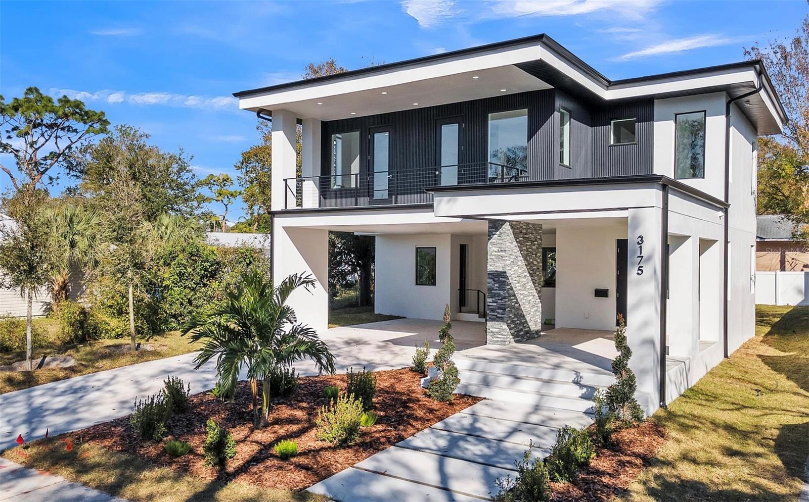 Live the dream in a Modern Sanctuary crafted by Atlas Development, a leading name in St. Petersburg's building scene. This beautiful home sits on a quiet street in a non-flood and non-evacuation zone near some of St. Pete’s renowned restaurants. This outstanding new construction model greets you with luxurious interior and exterior architectural detail including 20-foot ceilings. The custom-built fireplace, designed to stand out, creates the perfect entertaining space with a large living room for you and your family and friends to enjoy for any occasion. The open floor plan includes an elegant, chef-inspired kitchen featuring spacious custom solid wood design, 42-inch upper cabinetry with additional stack cabinetry with soft-close drawers and doors below the kitchen island. The spacious kitchen island with waterfall quartz counters add to the sophistication. Luxury vinyl plank floors flow seamlessly throughout, and large PGT hurricane impact windows flood the space with natural light. The second floor welcomes you with 9-foot ceilings and an entertainment view. All four bedrooms ensure privacy and tranquility. The owner suite is a true retreat, complete with an en-suite bathroom luxuriously designed to create an everyday spa experience, featuring multiple shower heads, a double vanity, and a large walk-in closet. The second and third bedrooms include their own private balconies where you can enjoy your morning coffee or unwind in the evening—it's the perfect blend of luxury and comfort. Extended front parking offers space for four vehicles, enhancing curb appeal.