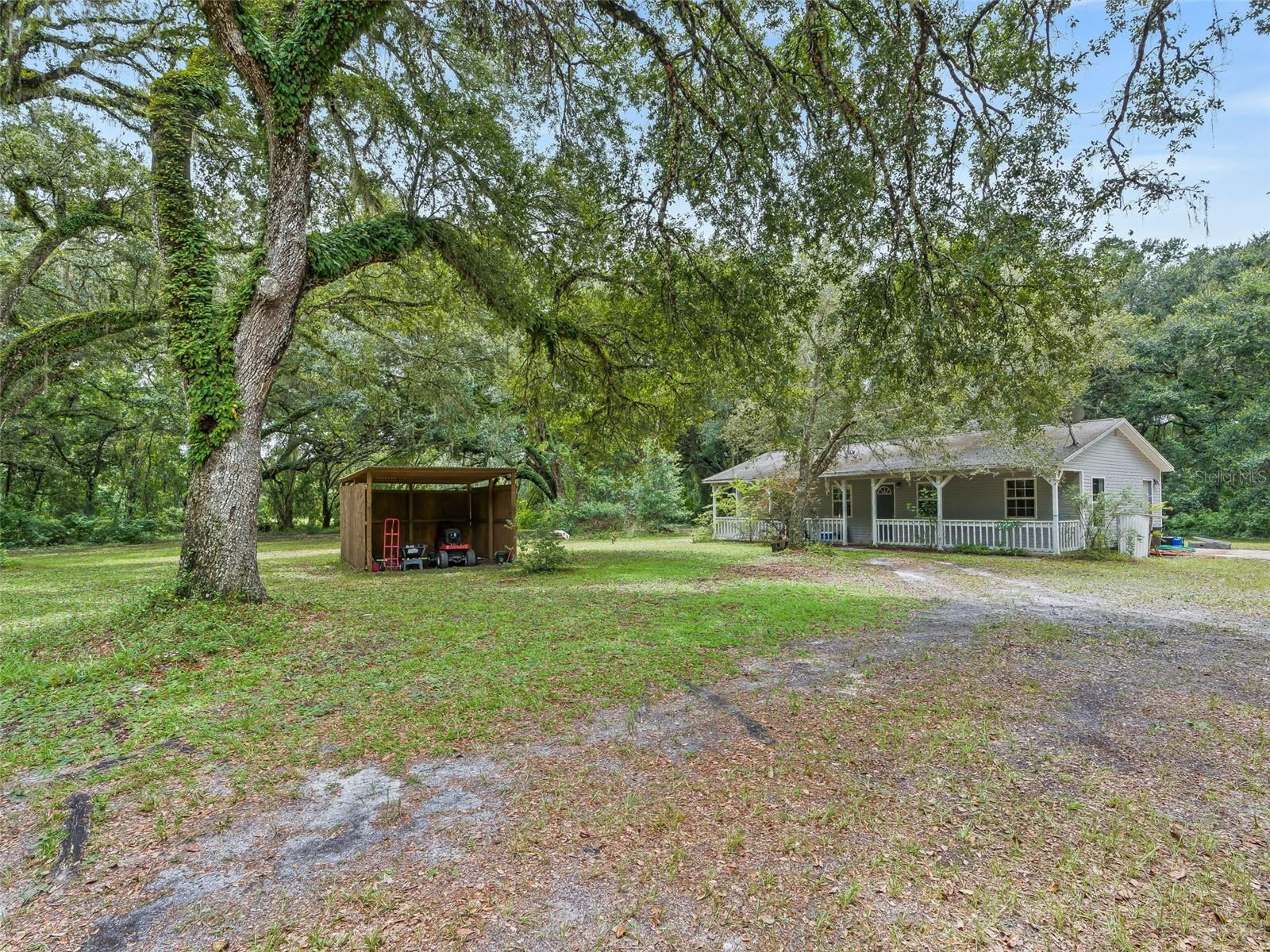 Charming 2BR/2BA Home – Country Living Close to Town! Discover peace and privacy with this 2-bedroom, 2-bathroom home set on 10.32 fenced acres in a serene rural setting, just minutes from town and major roadways. This spacious home features an inviting open-concept kitchen perfect for entertaining, with ample cabinet and counter space, a large center island, and a cozy eat-in dining area. French doors off the kitchen lead to a relaxing screened porch, the perfect spot to enjoy your morning coffee or evening drink. The home also offers a classic covered front porch, ideal for rocking chairs and unwinding after a long day. The living room is warm and welcoming, with plenty of space for gathering. Both bedrooms are generously sized, and the primary bath includes a beautifully tiled walk-in shower. Outside, enjoy the wide-open space shaded by trees, a storage shed with room for tools and equipment, and endless potential for gardening and hobbies. Whether you're looking for a peaceful retreat or space to grow, this property offers the best of both worlds—rural charm with convenient access to everything you need. Don't miss this opportunity to enjoy quiet country living with room to roam—schedule your private tour today!