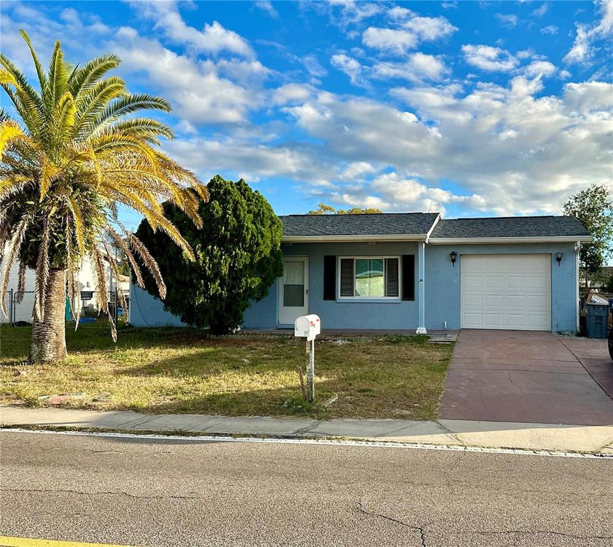 This updated 3-bedroom, 1-bath home boasts a new roof, a new AC and energy-efficient upgraded windows. Inside, the layout is well-designed, featuring a welcoming living area upon entry, two bedrooms and a bathroom to the left, a dining room to the right, a bonus room and an open kitchen overlooking the backyard through a large window. Outside, a spacious fenced backyard with a screened-in patio invites you to enjoy morning sunrises and coffee. Plus, the property is conveniently located near shopping, libraries, restaurants, parks, and just 45 minutes away from Tampa airport. NOT in a Flood Zone! The garage has been converted into the 3rd bedroom. Don't miss this fantastic opportunity!