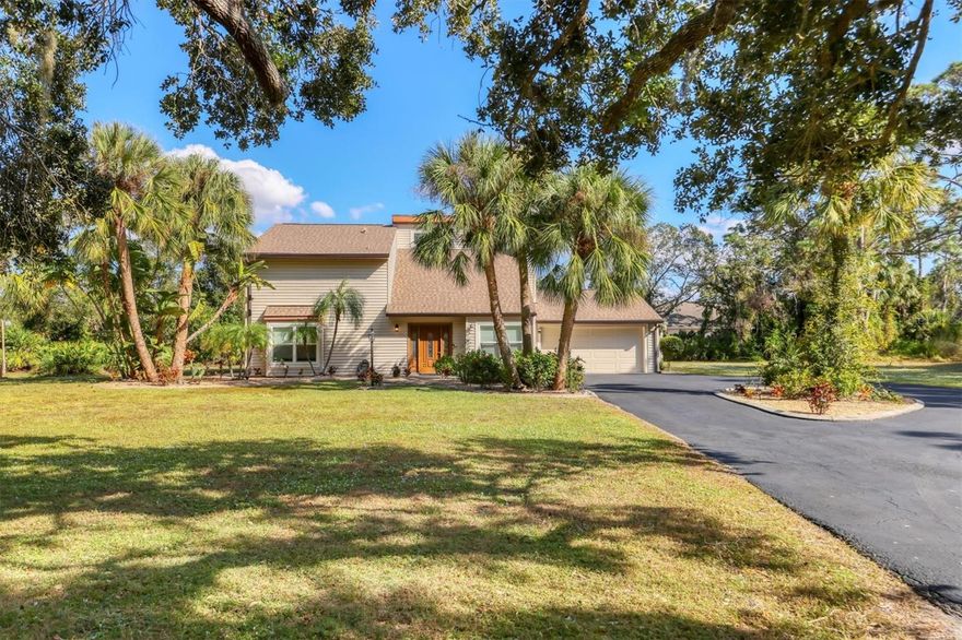 Value + space + privacy in Ravenwood—now is the time to see this one. This spacious two-story pool home sits on 1.09 acres with a private, tree-lined backdrop and a flexible layout built for comfortable everyday living and entertaining. A major highlight is the low total cost of ownership: enjoy an ultra-low annual HOA (approx. $200/year), septic (no sewer bill), city water, and natural Florida landscaping that’s beautiful, established, and easy to maintain. Inside, you’ll find 2,156 sq. ft. of air-conditioned living space with a first-floor primary suite, a cozy fireplace, and a refreshed interior—floors, walls, and ceilings have been updated by the sellers, with consistent tile flooring throughout the main level and upstairs. The kitchen is well-equipped with Thomasville cabinetry, Bosch dishwasher, GE dual-oven range, and a wine cooler. Upstairs offers two additional bedrooms (both with walk-in closets), a full bath, and a loft with sliders to the upper deck. 
Outdoor living shines with a heated pool, screened paver deck, covered lanai, outdoor shower, plus a newer screen enclosure and 2025 water heater. The oversized garage includes laundry, a reinforced garage door, custom flooring, and an exterior door to the backyard. Bonus: the oversized lot provides room to add additional living space, a garage, or a she-shed (buyer to verify). Convenient Sarasota location just off Desoto Road, between Lockwood Ridge and University Blvd—a must-see for buyers who want land, privacy, and lower ongoing expenses.