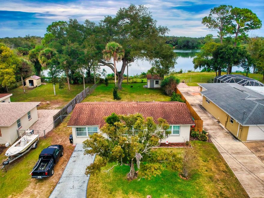 NATURAL BEAUTY, PRIVACY. This sweet home with artisan updates is a MUST SEE. The serene backyard abuts a small lake perfect for fishing or paddling. Bonus room can be bedroom (with closet), den or office. Inside laundry, storage shed/workshop (with power), plenty of room for boat or RV, pool. A/C 2014. Roof passed Sept 2020 wind mitigation. Virtual tour available! ;Water: City