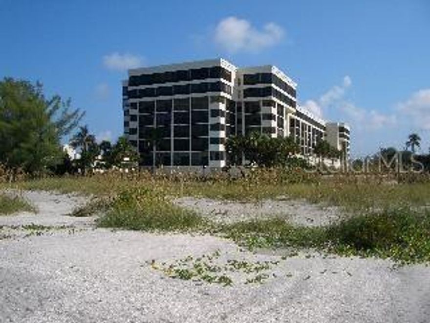 Lido Beach condo in Lido Surf and Sand, with a large porch overlooking views north up Lido Beach.  Step into this split plan two bedroom, two bathroom condo with views that are breathtaking. The condo has porcelain tile floors and stylish furniture.