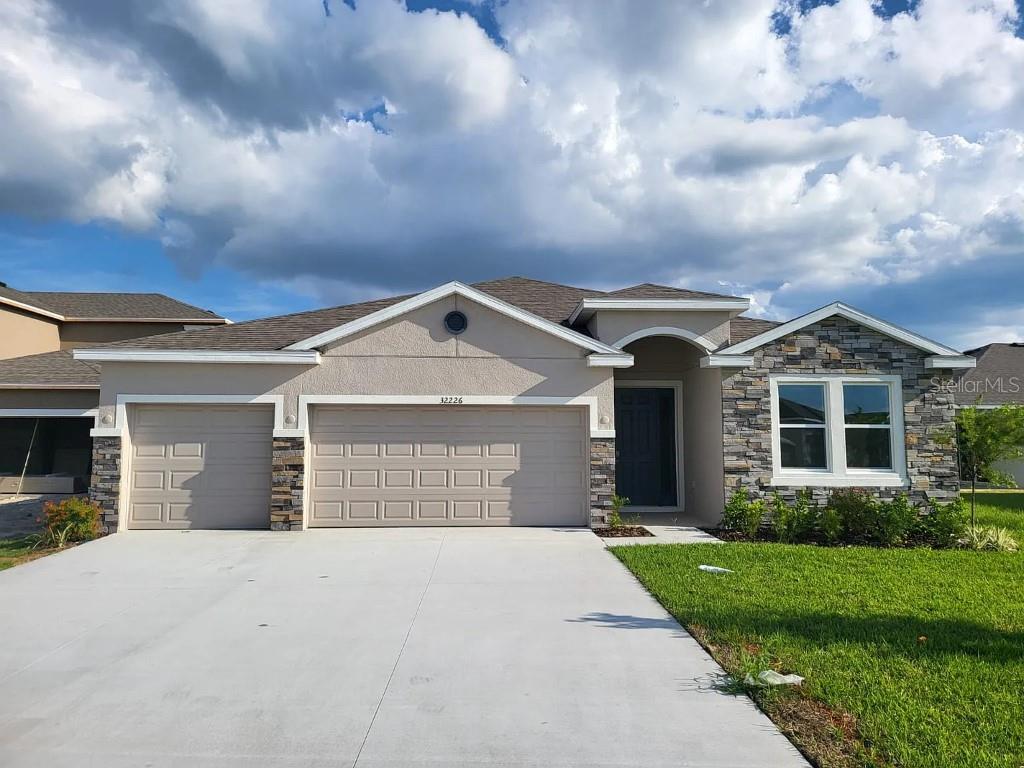 One or more photo(s) has been virtually staged. Your chance to own a gorgeous 4 bedroom 3 full bath 2024 home, offering extended living and dining spaces. Good curb appeal, high ceilings, elegant tile flooring, large kitchen island, numerous windows and abundant natural light are some of the special features you will find throughout this gorgeous home, making for a comfortable and relaxing space. An elegant foyer opens up to a stylish chef's kitchen with granite countertops, a electric cooktop, ample cabinetry, upgraded backsplash, plus an expansive island with bar seating. Retreat to an expansive primary bedroom and owner's extended walk-in shower featuring a custom large walk-in closet finish out. An optional flex space makes a good office or home gym. Enjoy outdoor living and entertaining on a covered extended lanai. Ample storage and parking including a spacious 3 car garage. Great schools. This home checks all the boxes!
Located off of SR-56, Woodcreek offers new homes in Wesley Chapel with a prime location that you won't want to pass up. At the center of this growing city, you'll be just 15-minutes from I-75 and Tampa Premium Outlets, Main Event Entertainment, and just 5-minutes from Wiregrass Mall and its several dining establishments such as Grill Smith, Red Robin, Noble Crust, and countless other options. Several hospitals serve the area such as St. Joseph and Advent Health, which is just minutes from the community. Pasco County Schools are within 10 minutes of Woodcreek, as is the soon-to-be Wesley Chapel Sports Complex. Popular grocery stores like Target and Publix are all right down the road as well.