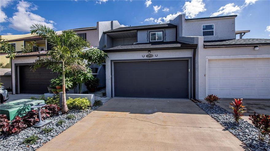 NO HOA FEES! Experience luxury lakefront living in this stunning 3-bedroom, 2.5-bath smart townhome on Lake Suzy, offering breathtaking panoramic water views and over $380,000+ in high-end personal designer upgrades throughout. This beautifully redesigned two-story residence features a dramatic floor-to-ceiling glass atrium, three scenic lanais, and seamless indoor-outdoor living. Major improvements include a NEW ROOF (2022), TWO NEW AC systems, updated electrical, energy-efficient smart hot water heater, and $80K in hurricane-impact windows and sliders. The chef’s kitchen is a true showpiece with Café smart appliances, induction cooktop, quartz countertops, custom shaker cabinetry with illuminated glass uppers, pot filler, designer range hood, and built-in kegerator — all blending modern luxury with functionality. Smart-home features allow control of AC systems, lighting, and hot water heater directly from your phone. The open living space showcases luxury waterproof wood plank flooring, electric fireplace, custom shelving, and designer finishes throughout. The primary suite offers sweeping lake and atrium views, a private double balcony, spa-style bath with dual sinks, double shower, and a custom boutique closet with chandelier. Two additional bedrooms provide serene views, specialty lighting, and beautifully updated baths. Step outside to your custom metal diamond-cut dock, perfect for enjoying peaceful sunrises and untouched natural surroundings. This one-of-a-kind lakefront townhome combines architectural design, smart technology, and extensive upgrades—creating a truly exceptional waterfront lifestyle. Schedule your private showing today.