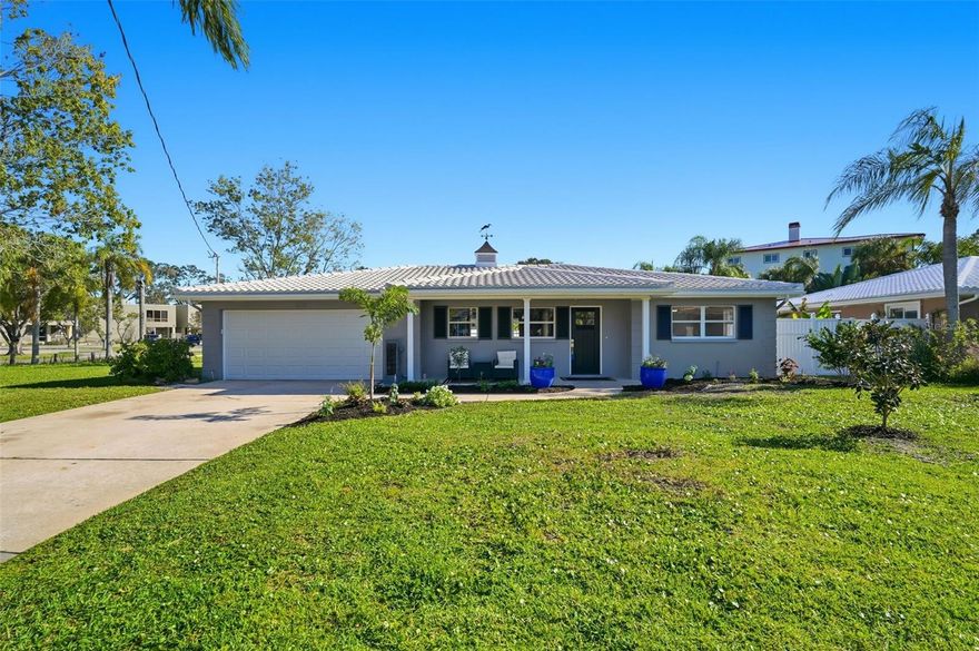 One or more photo(s) has been virtually staged. Welcome to this beautifully renovated three-bedroom, two-bathroom pool home in the desirable Dunedin Shores community. With a brand-new 2025 AC system, new flooring, kitchen, and bathroom updates, all located just 7 minutes from Downtown Dunedin. Sitting on a corner lot near the Pinellas Trail and just 5 minutes to the Dunedin Causeway, this home offers a true Florida lifestyle with modern upgrades. Enjoy pulling up to the new landscaping, while the front porch provides a perfect spot to enjoy the coastal breeze. Step inside to find a bright and open floor plan with new luxury vinyl plank flooring throughout, stone tile in the kitchen, crown molding, updated fans, and premium light fixtures. The spacious kitchen, dining, and living room combo is perfect for entertaining, featuring a working wood-burning fireplace and abundant natural light. The updated kitchen showcases quartz countertops, a farmhouse sink, shaker-style soft-close cabinets and drawers, LG stainless steel appliances, pendant lighting, and a breakfast bar for casual dining, along with a built-in kitchen booth/chef’s table for extra seating. The primary suite has been beautifully renovated with new tile, cabinets, and finishes in the ensuite bathroom, plus a walk-in closet. The second bedroom also features a walk-in closet, providing ample storage space. Every detail has been carefully curated, including higher-end doors and hardware throughout. Outside, a sprinkler system with a new controller and a sparkling pool perfect for relaxing or entertaining. The deck area is ideal for grilling and outdoor dining, while the fenced backyard features a serene koi pond for added charm. This move-in-ready home is close to local dining, boutique shops, coffee spots, parks, the Dunedin Golf Club, shopping centers, and the Dunedin Community Center. Come experience all that Dunedin Shores has to offer! Schedule your tour today!
