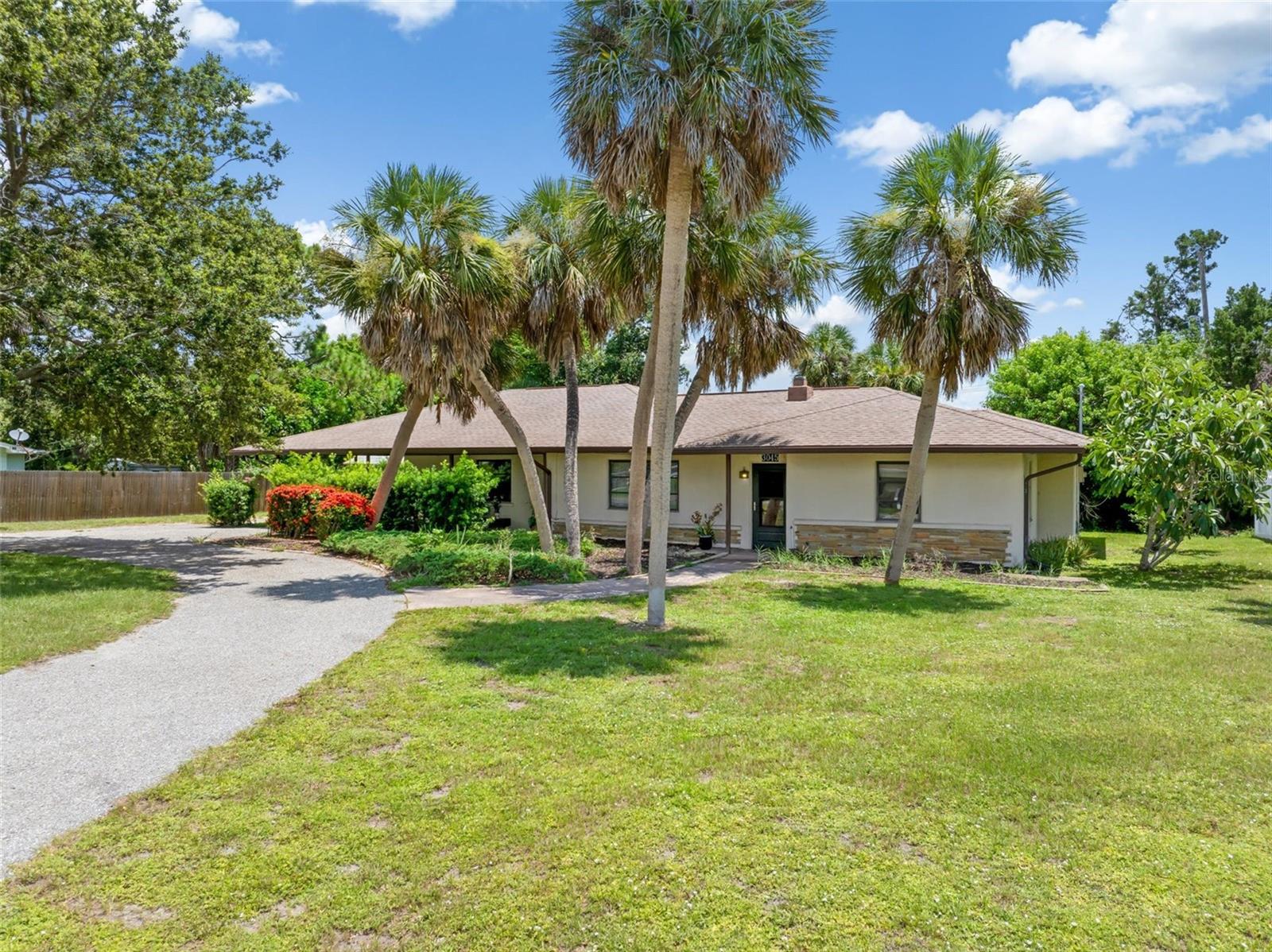 MULTI-GENERATIONAL LIVING JUST MINUTES FROM THE BEACH! Being sold TURNKEY FURNISHED!
This inviting ranch-style home offers over 1,800 square feet of thoughtfully updated living space, complete with a private in-law suite. Featuring three bedrooms and two bathrooms, the layout provides both comfort and flexibility for multi-generational living or hosting guests.
Step inside to a bright, welcoming living room anchored by a striking wood-burning stone fireplace. A wall of windows in the living and kitchen areas fills the home with natural light, while the open floorplan makes entertaining effortless. The kitchen is equipped with an island and ample space for a full-size dining table. Recent updates include fresh paint, luxury vinyl plank flooring, modern lighting, and new appliances throughout.
The main home features two spacious bedrooms with generous closets and a fully updated bathroom. Separated by locking doors for privacy, the in-law suite offers its own living area, a full kitchen, a large bedroom with an en-suite bath, walk-in closet, and separate laundry hookups on the back patio.
Outdoors, the circular driveway enhances curb appeal and provides plenty of parking alongside a carport and additional storage in the backyard shed. The optional South Venice HOA offers access to a community beach ferry and additional amenities, all with no required fees.
Set on over a quarter-acre lot in a quiet neighborhood, this move-in ready property is just minutes from shopping, dining, schools, and the beautiful Gulf beaches.