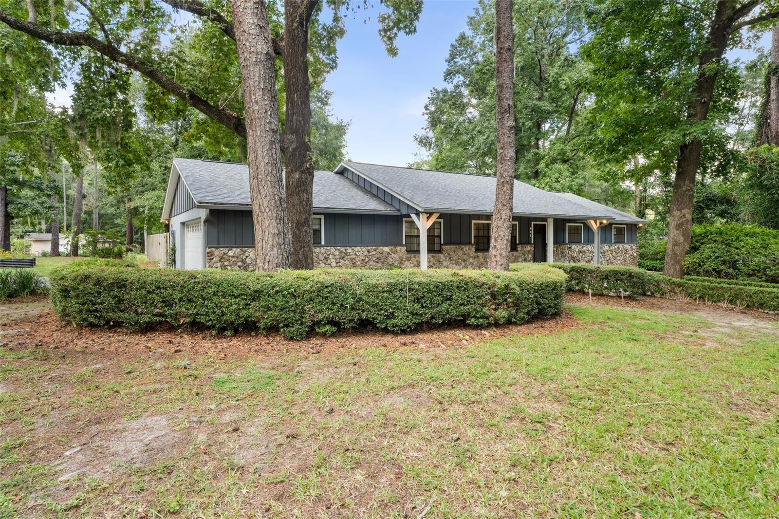 One or more photo(s) has been virtually staged. LOCATION, LOCATION, LOCATION! Live less than 3 miles from the University of Florida and under 5 miles from UF Health Shands Hospital, while enjoying the peace of a quiet neighborhood with no HOA. This beautifully updated 3-bedroom, 2-bath home is truly move-in ready. Inside, you’ll find a spacious living room with a cozy wood-burning fireplace, a large open kitchen with stainless steel appliances and a backyard view, plus a flexible office space and dining room with elegant French doors. The generous primary suite is a true retreat, featuring two closets — including an extra-large walk-in closet with custom built-in shelving for maximum storage and organization. Step outside the sliding glass doors to your private oasis — a paver patio with a pergola overlooking lush landscaping and a fully fenced backyard, perfect for morning coffee or evening gatherings. Additionally, for added peace of mind, all the major systems have been taken care of: NEW ROOF in 2021, NEW HVAC in 2020, and NEW HOT WATER HEATER in 2025. Conveniently and centrally located near the University of Florida, UF Health Shands Hospital, Archer Road shopping and dining, Thornebrook Village, Loblolly Trails and Westside Park, this home offers the best of both worlds: central convenience with neighborhood charm.