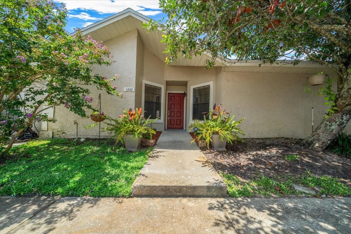 Welcome to this light-filled 2-bedroom, 2-bath villa in the heart of Ocala. With 945 square feet of thoughtfully arranged living space, vaulted ceilings, fresh paint and new flooring throughout, the interior offers a fresh, airy atmosphere from the moment you walk in.
The main living area flows naturally into a defined dining space and corner kitchen, complete with wood cabinetry, a full appliance suite, and laundry access. The layout separates the bedrooms for added privacy, with the primary suite offering a walk-in closet and an en suite bath with step-in shower. A full guest bath, interior laundry, and designated foyer entry round out the interior. Sliding doors open to a tiled screened porch with a private storage closet and a view of the open green space beyond.
Just across the street from the pool, this villa enjoys one of the best locations in the community. Residents have access to a large pool with sundeck, shaded seating, and a relaxed neighborhood atmosphere. HOA dues include roof and exterior upkeep, lawn service, trash collection, and pest control, offering ease of ownership close to medical centers, shopping, and Downtown Ocala.
