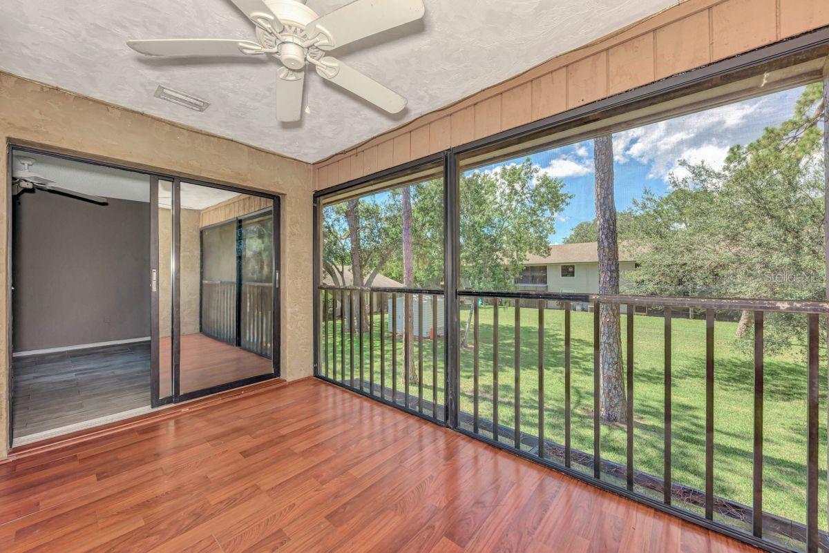 A fantastic find in a prime location! This spacious, two-bedroom, two-bathroom unfurnished condo is just minutes from the vibrant attractions of Siesta Key, Gulf Gate, Detweiler's Farmers Market, and downtown Sarasota. The open-concept great room, with its high ceilings and sliding glass doors, offers beautiful natural views, while the relaxing, screened-in balcony provides the perfect spot to enjoy a tranquil Florida evening overlooking lush green space. The kitchen features an island with seating for barstools and a convenient built-in desk. You'll also find tasteful tile and stone countertops in the bathrooms, and the rest of the condo is free of carpet, offering a clean and fresh feel. The unit includes a washer and dryer, plenty of storage, a private covered carport, access to a community pool, and well-maintained grounds.