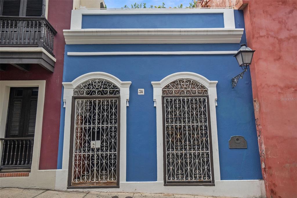Take the journey throughout this 5,500 sq. ft. piece of history. An exquisite contrast of modern amenities and beautifully preserved Spanish colonial architecture dating back to the 1600s.
As you come in by the “zaguán”, you will be entering through the first of three “historic rooms” so designated by the Institute of Culture of Puerto Rico. The historical integrity of the property is evident in the architectural portholes known as "ojos de buey" – a type of cut-out window used to provide cross ventilation. Above the remaining original wooden doors, you can appreciate the semicircle shaped fanlight windows known as "soles truncos".
First Floor: 16’ ft. ceilings make the already impressive first floor seem even grander. A lush interior courtyard patio serves as the unifying element providing natural light and cross ventilation, although all rooms are equipped with air conditioning. Formal living and dining rooms. Family room with built in storage and a half bath. Guest room with a full bath. Comfortable and private home office. Additional office or multipurpose room.
Second Floor: An elegant wooden balcony hangs above the courtyard and serves as an outdoor space. Master suite with spacious ensuite bathroom, sitting area with a large skylight and a private rooftop terrace. Three additional bedrooms each with private bathroom.
Third Floor: Array of solar panels.
Amenities:
- Two (13.5 kWh) Tesla Powerwall 2.0 batteries
- 7.015 KW solar system that covers approximately 90% of the property's energy requirements. (23 solar panels)
- Subterranean water cistern (aljibe) with a 12,000-gallon approx. capacity
- Reverse osmosis water purifier.
- Two electric water heaters and one gas water heater.
Features:
- Total GLA: 5,500 sq. ft. / 226 sm lot.
- 4,000 sq. ft. of interior living space + 1,500 sq. ft. exterior (semi-covered courtyard and rooftop terrace).
- Zoning: C-3 - The property is currently being used as a single-family residence, but zonification allows for various uses such as a multi-tenant apartment building, a historic guest house or operated as a mixed-use commercial-residential property.
- Property Taxes: The property is certified by the Puerto Rico Institute of Culture for having maintained historical integrity and is exonerated from paying property tax fees and rental capital gains until 2026. The certification is renewable.
- Historical Notes: The property was once home to Juan Tizol, famous Puertorrican Jazz composer who wrote music showcased by Duke Ellington, Nat King Cole, Ella Fitzgerald, and many other world-renowned musicians. The property was also used as a music school.