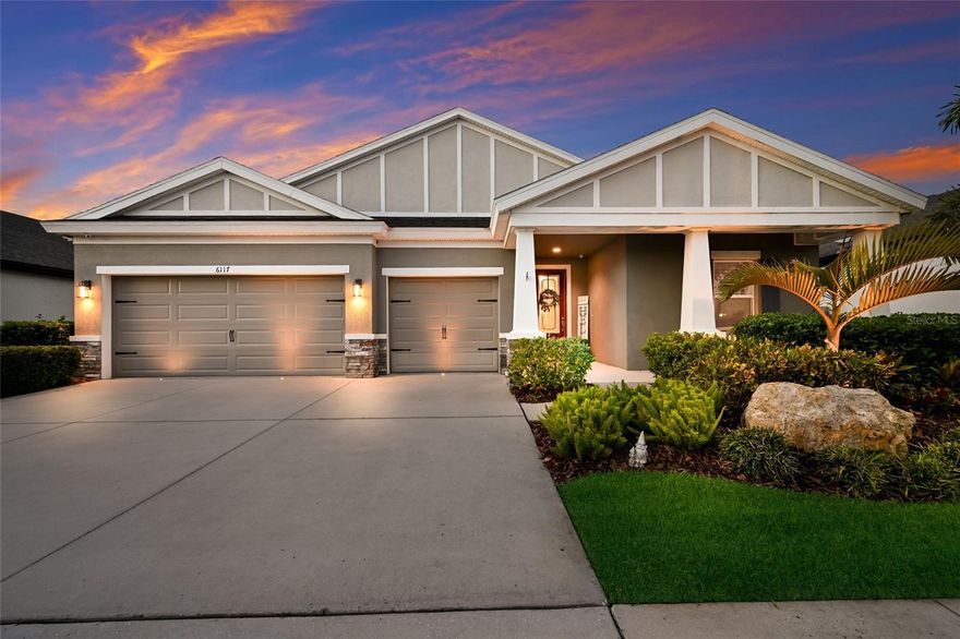 Welcome to this stunning, better-than-new 3 bedroom plus den, 3 bath, 3 car garage pool home in the highly sought-after community of Waterset. Built by Homes By WestBay and thoughtfully designed with smart home technology & a well appointed outdoor kitchen, it offers an inviting setting for effortless, stylish entertaining. With its wide driveway, custom landscaping, & welcoming front porch, this Craftsman-style home opens to a spacious entryway & an airy triple-split floorplan designed to maximize both comfort & functionality. Off the hallway, a spacious flex room/den w/double doors offers privacy & versatility as an office, home gym, media room, or even a 4th bedroom. Just beyond the den is your HUGE open concept kitchen and eat-in cafe that overlooks the expansive Great Room including adjacent Formal Dining Room. Impressive 24 foot wide sliders are a focal point in the Great Room & create a seamless transition between indoor & outdoor living. The gorgeous kitchen features extended 42" cabinetry, under-cabinet lighting, quartz counters, natural gas cooktop w/stainless hood, apron front single-bowl sink, sleek subway tile backsplash, & dedicated pantry. Stainless appliances, including double wall oven & beverage/wine fridge, & LG French door refrigerator make cooking a pleasure in this modern culinary space. Adjacent to the kitchen, the spacious kitchen cafe effortlessly accommodates both casual dining & upscale gatherings. Step into a lanai designed as a private resort-style sanctuary. At its center is a NEWER heated saltwater pool (2022) with sun shelf & tranquil waterfall. The amazing outdoor kitchen is shaded by a pergola & includes a three-burner grill w/rotisserie, Kamado smoker, fridge, sink, storage cabinets, trash bin, & concrete bar top. The cherry on top of your entertainment oasis is the outdoor Sonos system - imagine the incredible gatherings you can host out here! Surrounded by lush tropical palms & privacy hedges, this outdoor sanctuary offers a serene setting for both entertaining & relaxing in the Florida sun. Back inside, the primary retreat is a peaceful haven with views of the lanai, complemented by an expansive en-suite bath including a floor-to-ceiling tiled walk-in shower, quartz dual-sink vanity, & 2 massive walk-in closets. Toward the front of the home are two generous guest bedrooms, each w/access to its own full hallway bath, while the laundry room includes an Electrolux washer & dryer, upper cabinetry, & a stylish backsplash for a polished, functional space. Additional notable upgrades include Security sensors on all windows & doors; Outdoor security cameras; Landscape lighting; Lutron Smart Switches & Control Module; Smart Wi-fi thermostat; In-Ceiling Speakers in Great Rm & Lanai; Plantation shutters throughout; NEWER Whole home water softener & filtration system (2022); NEWER Premium carpet in Primary Bedrm (2024); External Generator connection; Overhead storage racks in garage & More. Situated in highly desirable Waterset, this master-planned community showcases world-class amenities including clubhouses, fitness centers, sports courts (pickleball/tennis/basketball & more), multiple resort-style pools, over 12 miles of trails & more than 10 parks including dog parks & playgrounds. PERFECT for those seeking the active Florida lifestyle! Conveniently located w/quick access to I-75, Big Bend Rd, 41 & 301, and just minutes from shopping & dining, St. Joseph's Hospital South, & an easy commute to MacDill AFB.