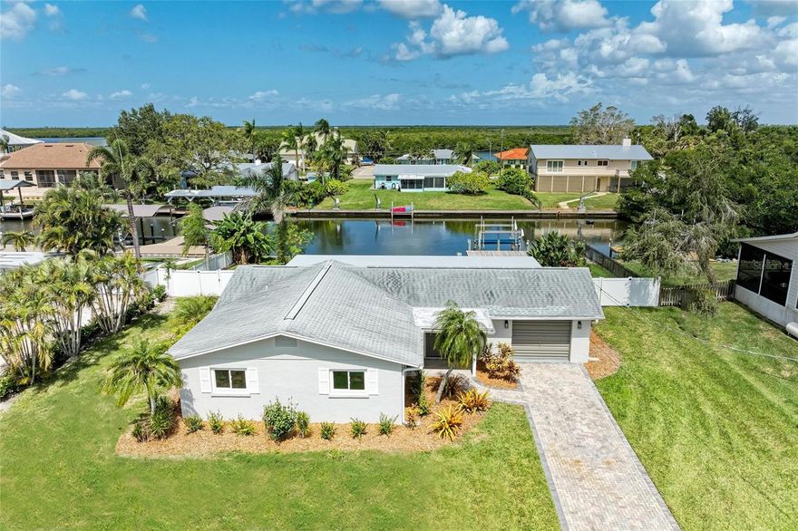 One or more photo(s) has been virtually staged. Welcome to this beautifully renovated canal-front 2-bedroom, 2-bath home located in Gulf & Bay Estates on Snead Island, a quaint and peaceful waterfront community. This exceptional property offers direct access to Terra Ceia Bay, Tampa Bay, and the Gulf of Mexico, making it perfect for boating and enjoying the coastal lifestyle. Every aspect of this home has been meticulously renovated, featuring new impact windows and front door, along with a new septic system and drain field. The Florida room has been completely rebuilt, showcasing Icynene foam insulation in the roof and walls, a new mini-split A/C, new hardie board, and a new flat roof. Interior upgrades include a brand-new kitchen with quartz countertops, modern cabinetry, and stainless appliances, complemented by two fully remodeled bathrooms. Additional upgrades include new electrical, solid-core doors and trim, new porcelain plank tile flooring throughout, and fresh interior and exterior paint. The exterior highlights include fresh landscaping, and a rebuilt dock, while the garage is enhanced with a durable epoxy floor system. The spacious backyard offers ample room for a pool, allowing you to create your own private retreat.
Just minutes away is the Bradenton Yacht Club, and Emerson Point Preserve offers a scenic network of hiking and kayak trails where you can experience over 200 species of birds and a wide variety of Florida’s coastal wildlife and natural habitats. With convenient access to St. Pete, Tampa, and Sarasota for world-class dining, shopping, sports, and airports, this home perfectly blends modern luxury, meticulous craftsmanship, and the ultimate waterfront living experience.